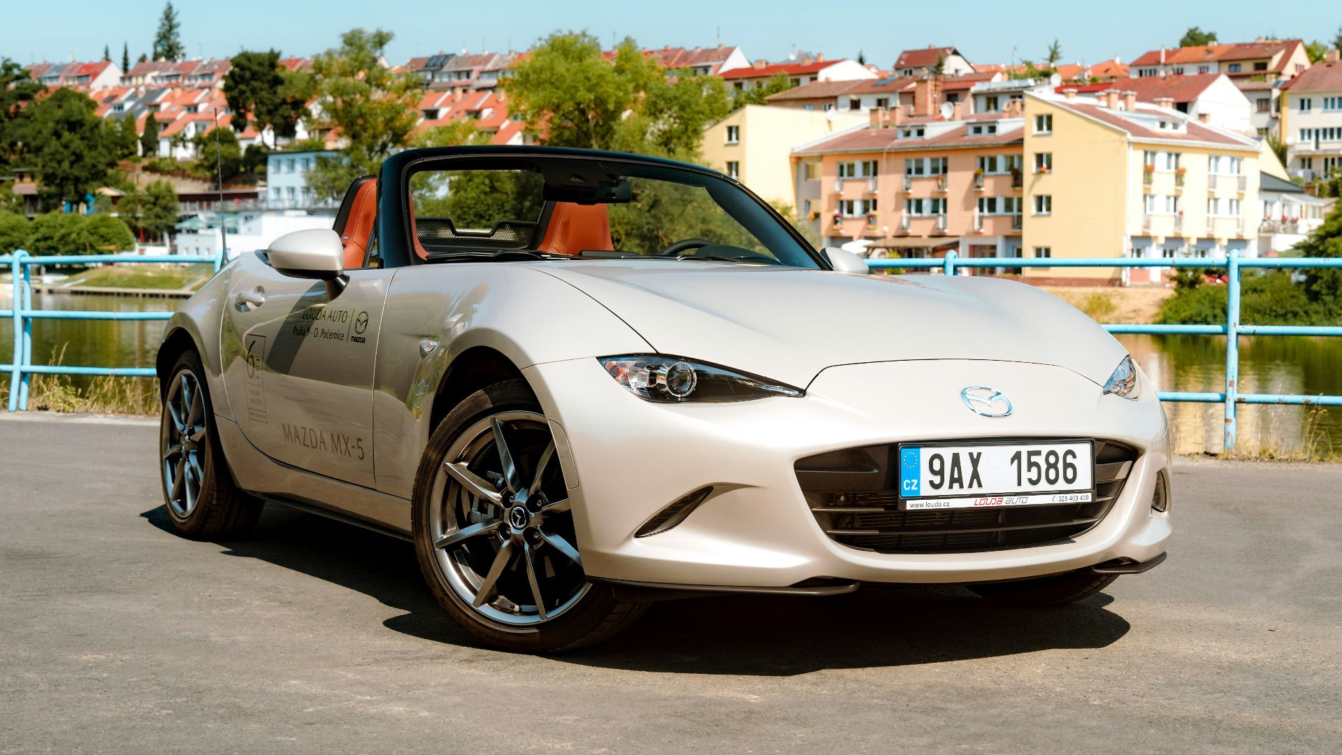 a white sports car parked in a parking lot