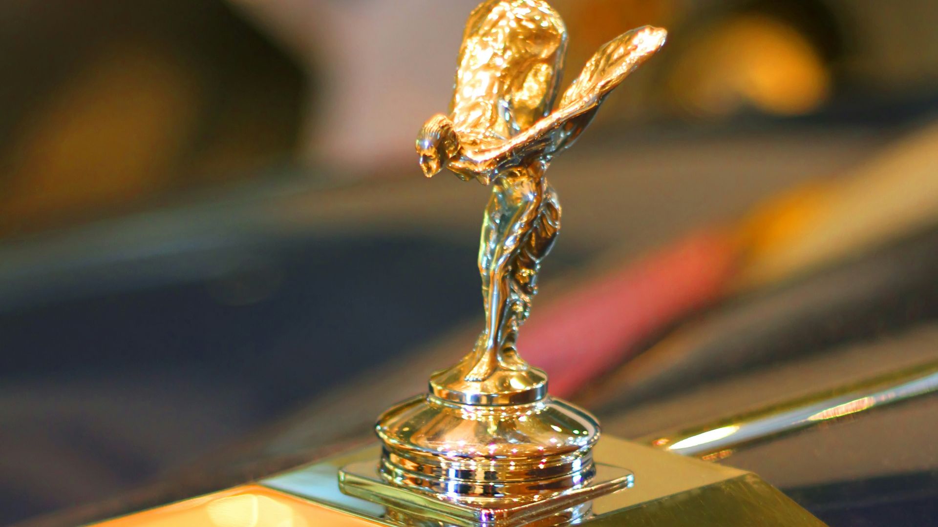 gold and black car hood ornament