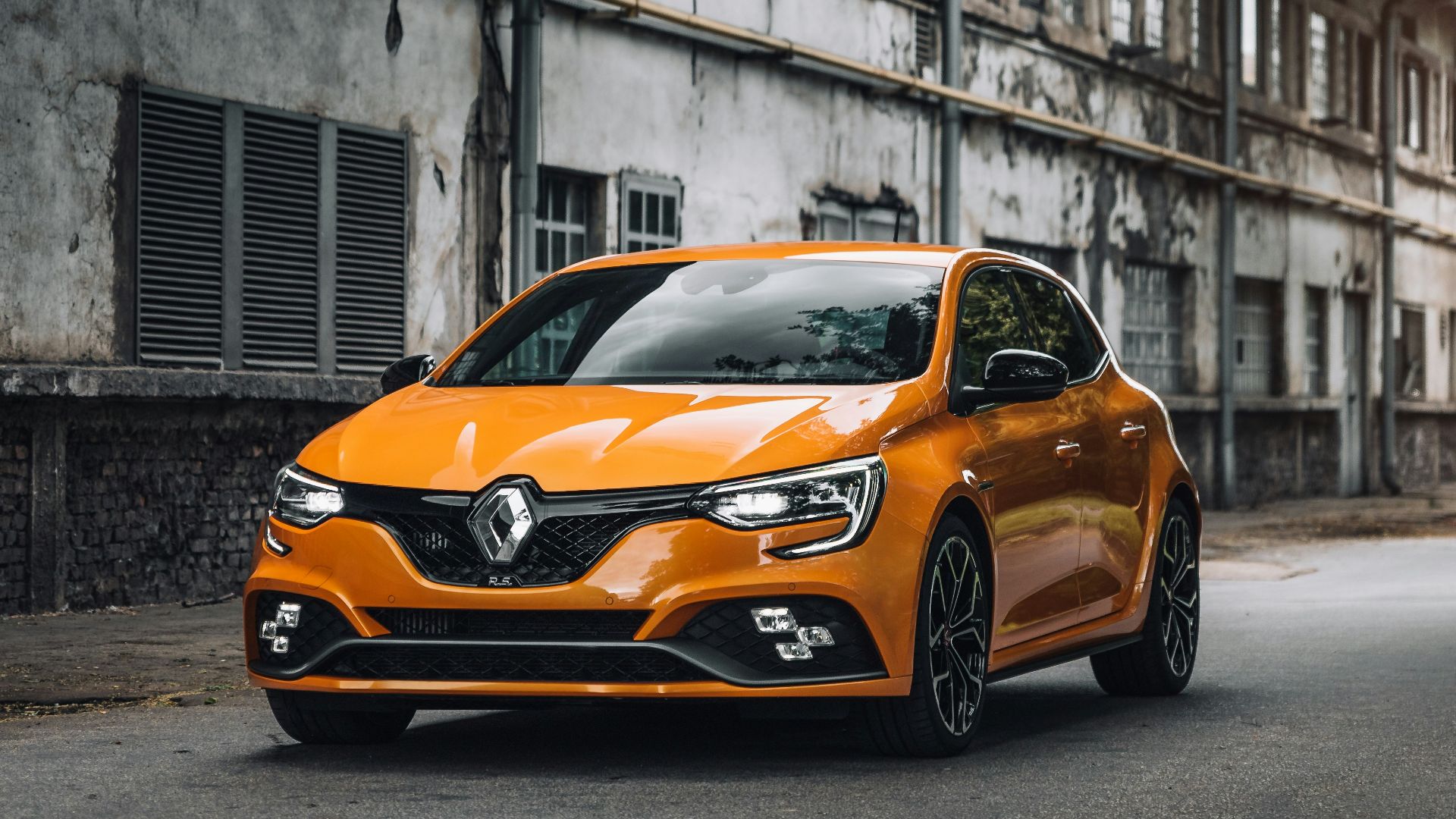 orange mercedes benz c class parked on street during daytime
