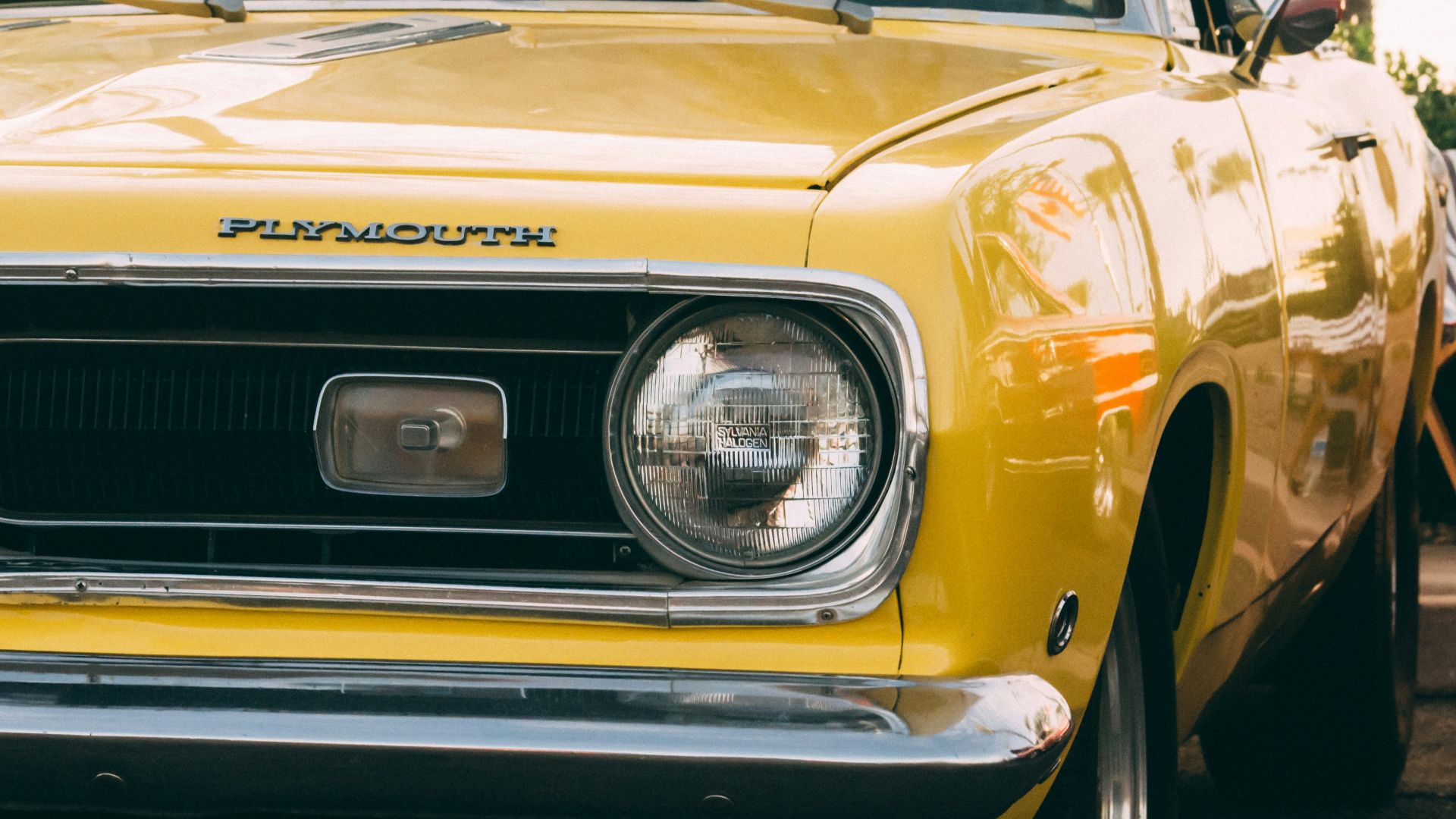 yellow vehicle parked beside deckchair