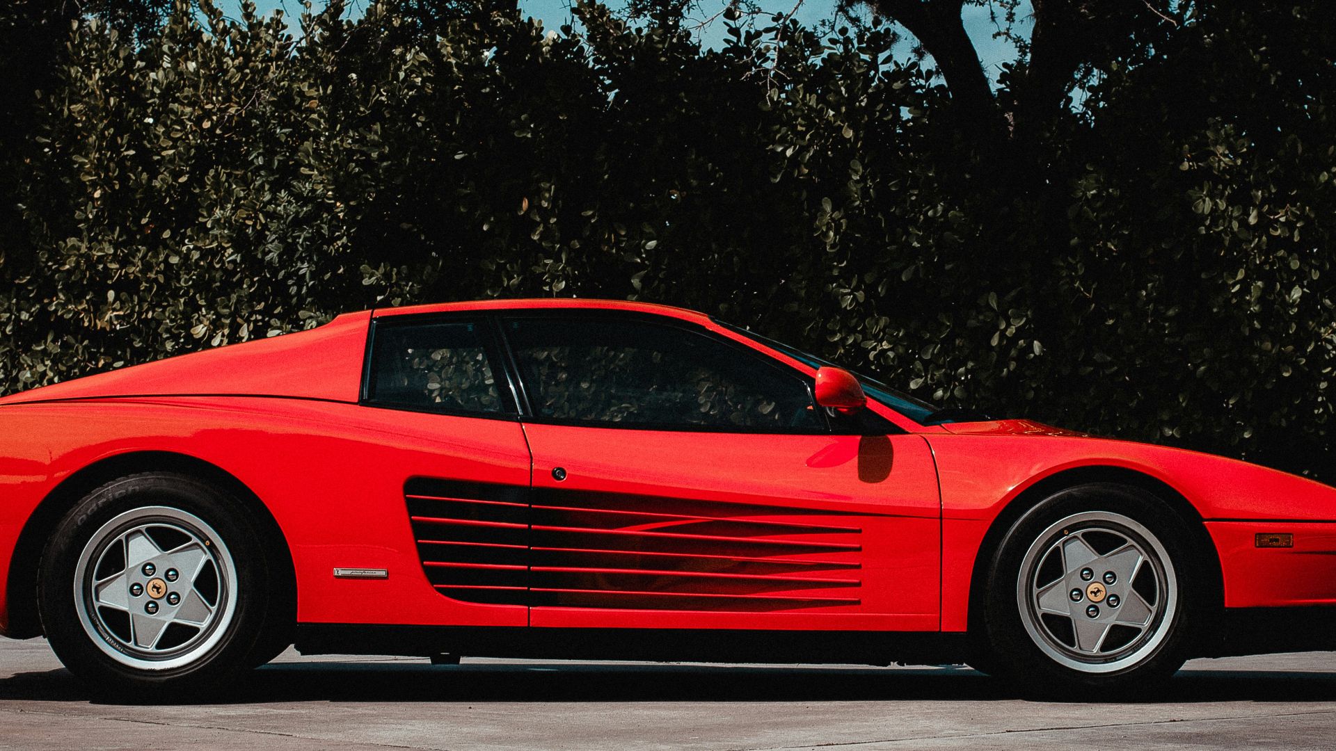 a red sports car parked in a parking lot