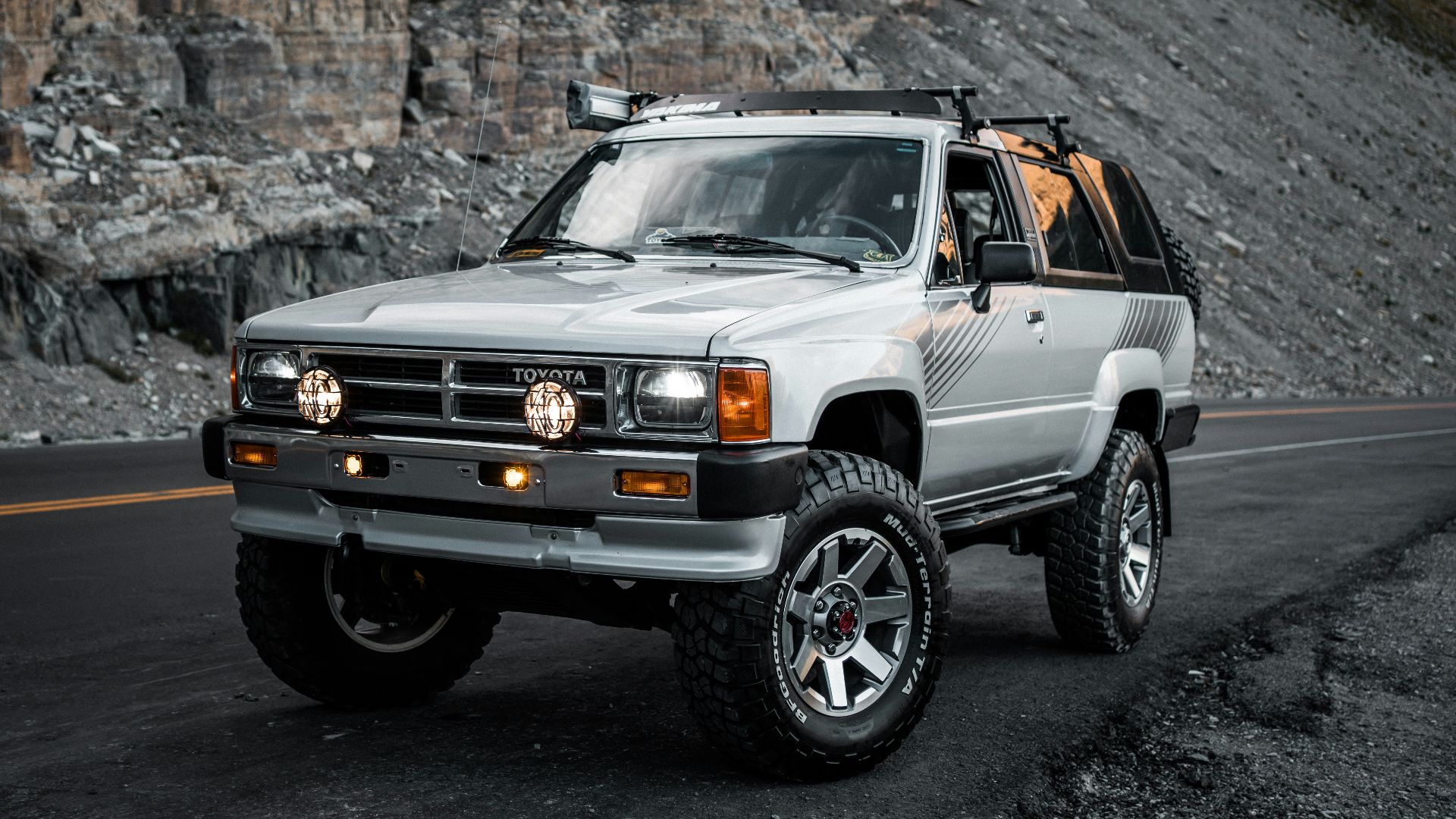 white jeep wrangler on black asphalt road