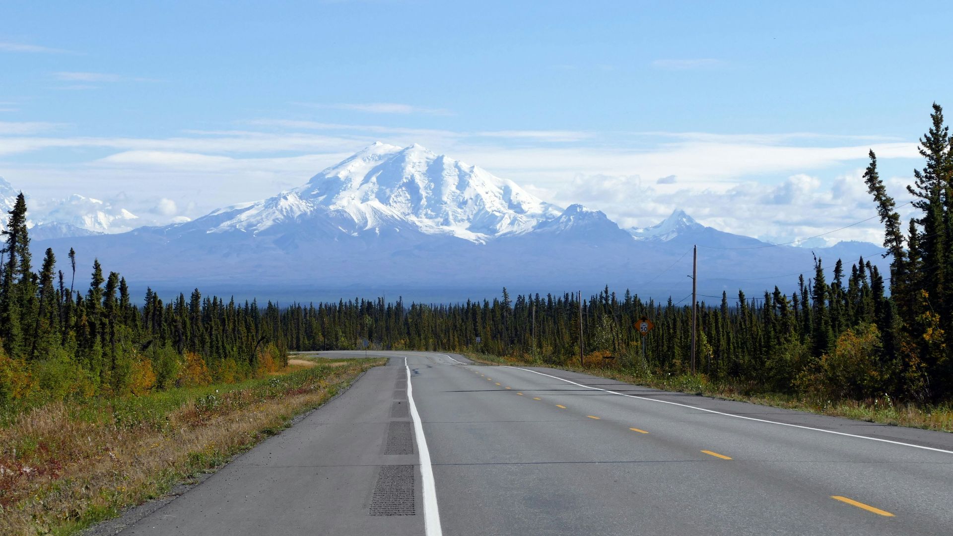 a road with a mountain in the background
