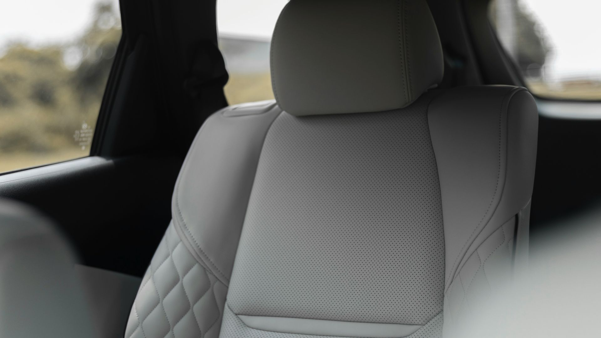 the back seats of a car with a view of a field