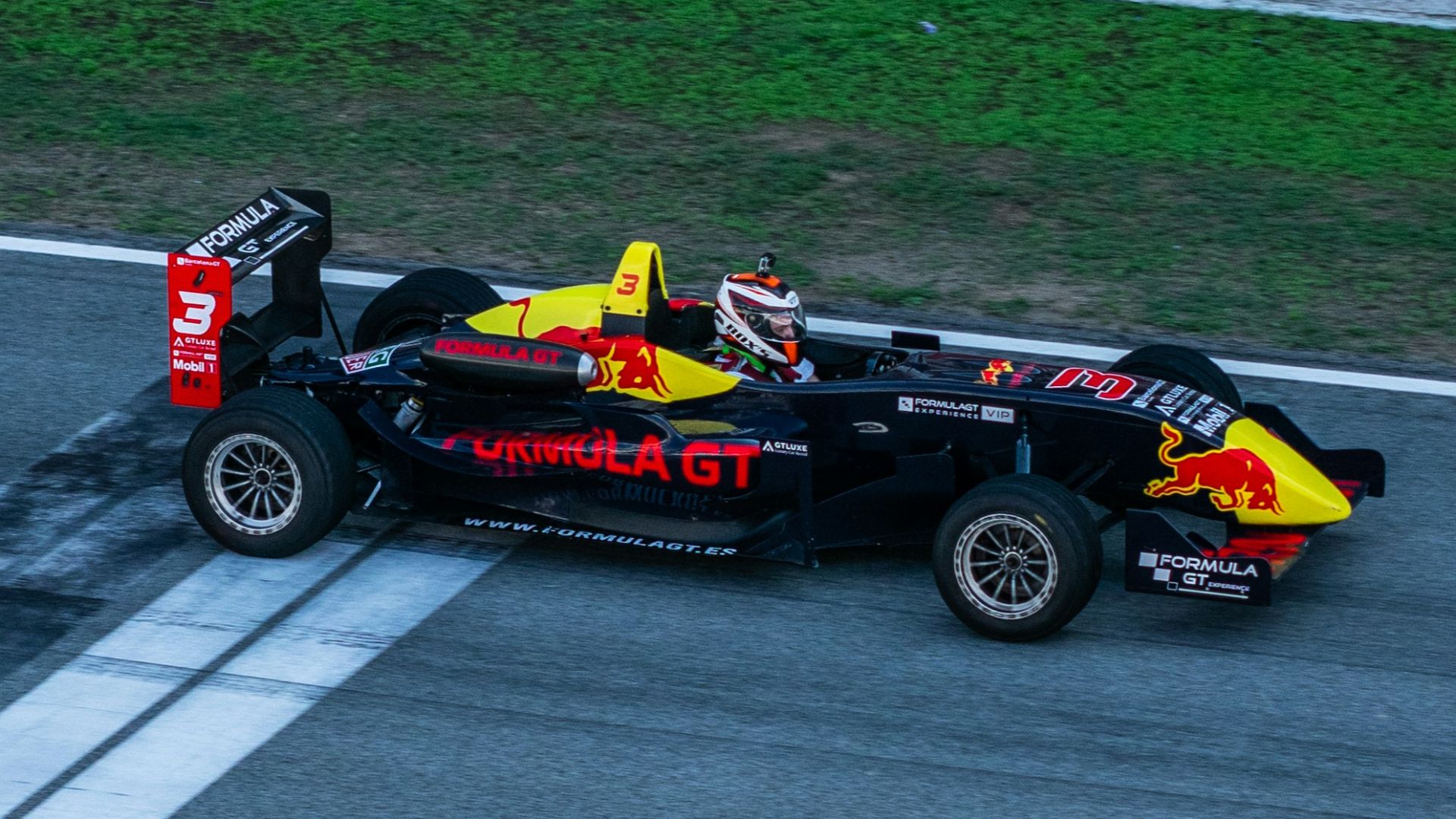 a red and yellow race car driving down a race track
