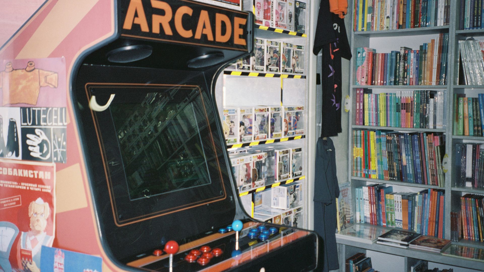 An arcade machine in front of a bookshelf