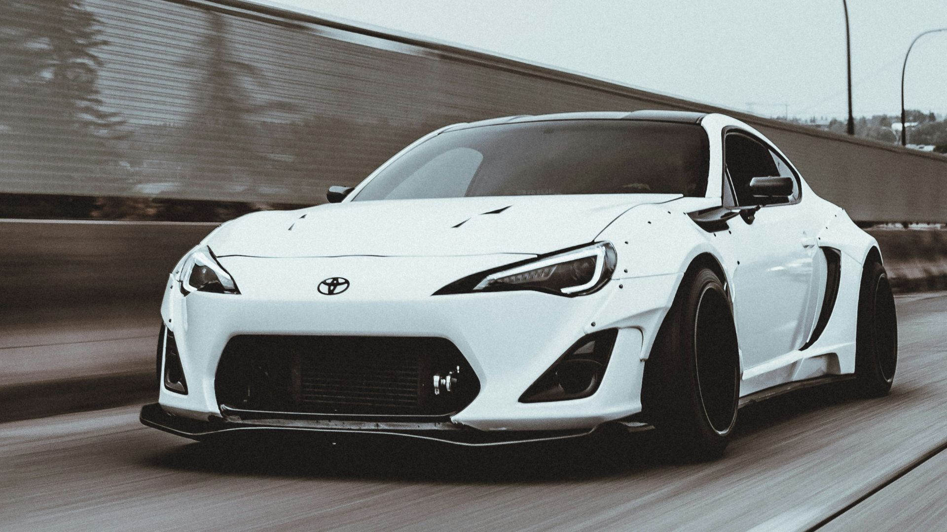 white porsche 911 on gray pavement