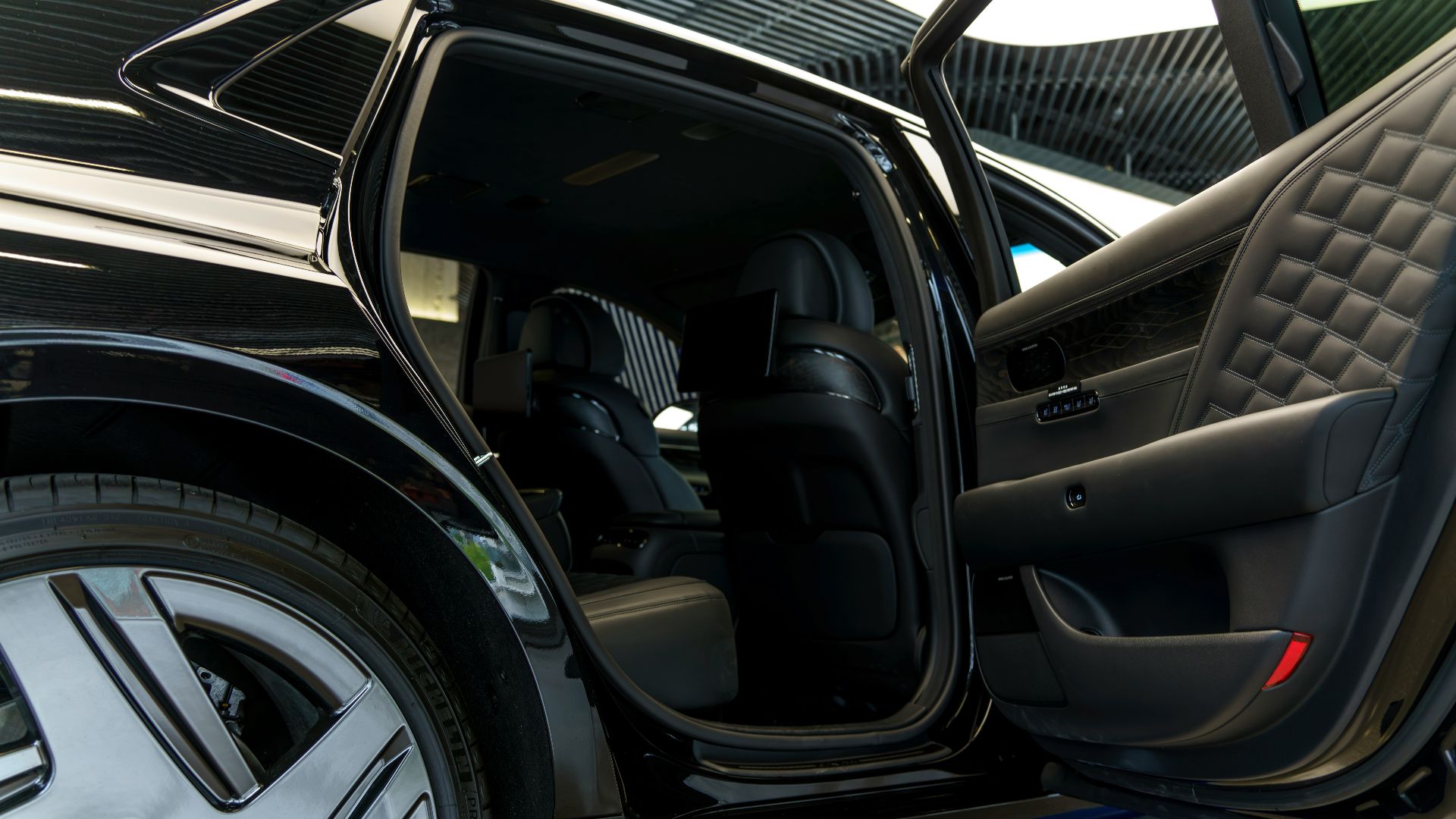 a car with its door open on a showroom floor