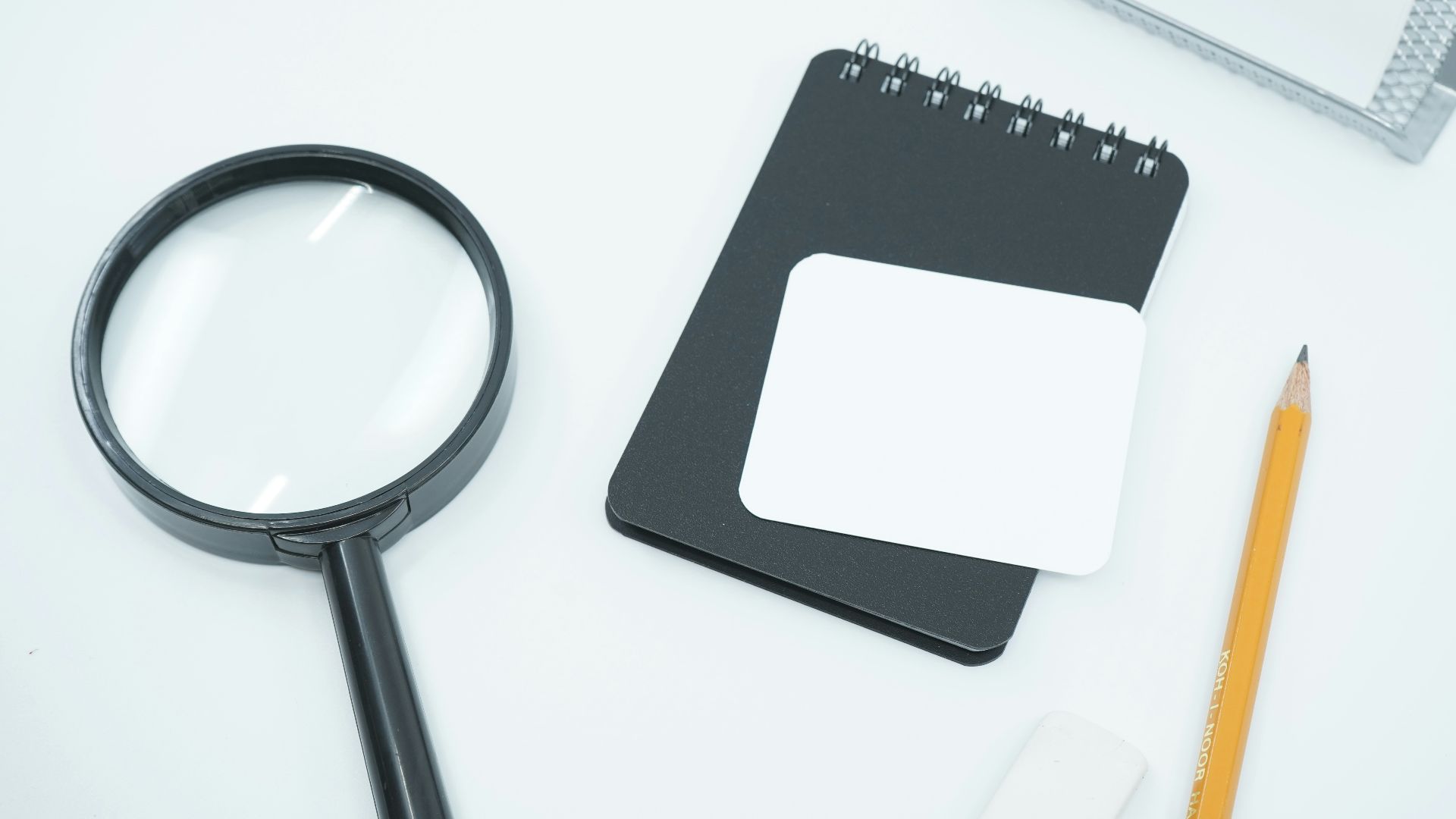 black magnifying glass on white paper