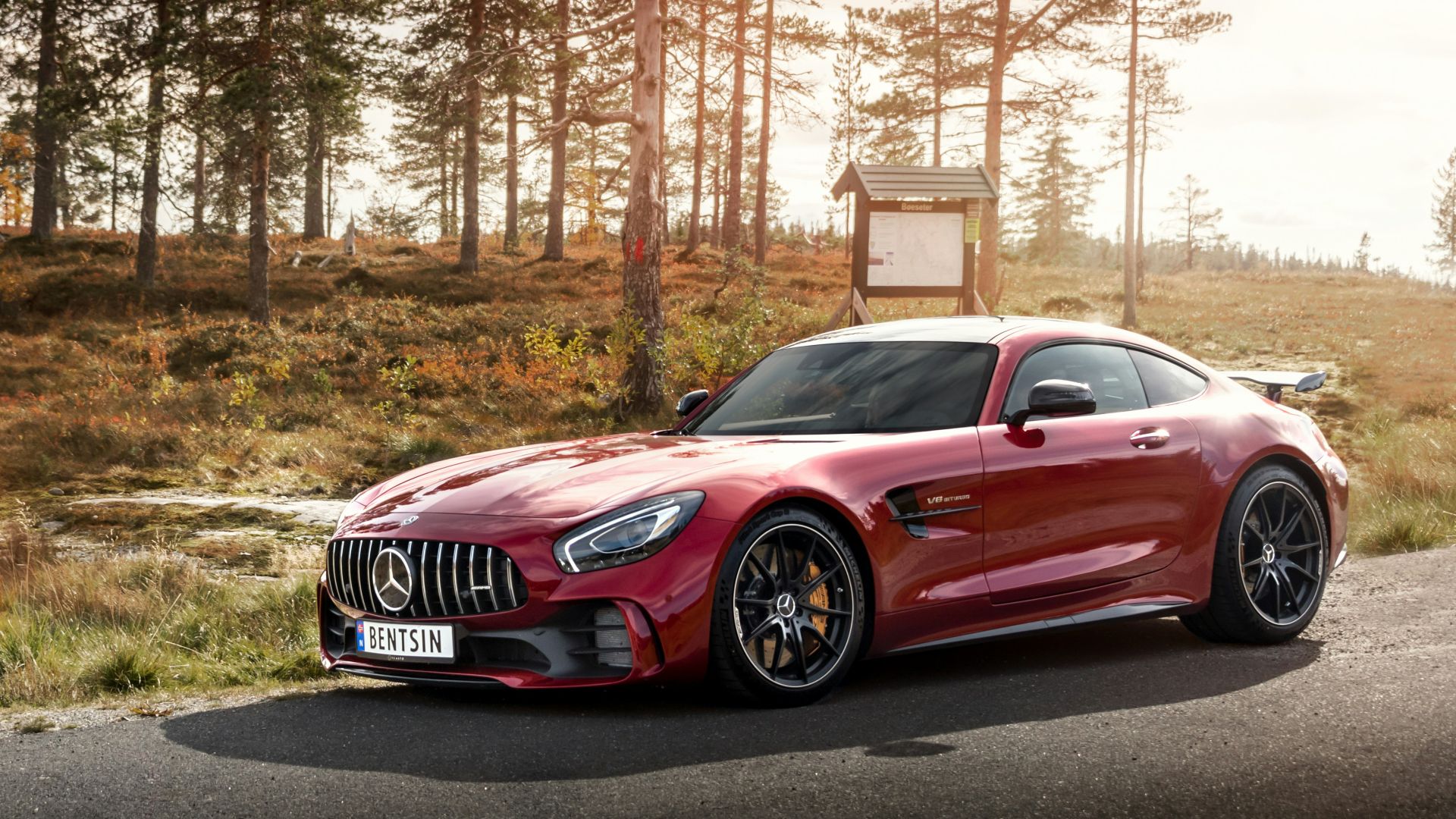 red Mercedes-Benz coupe on road