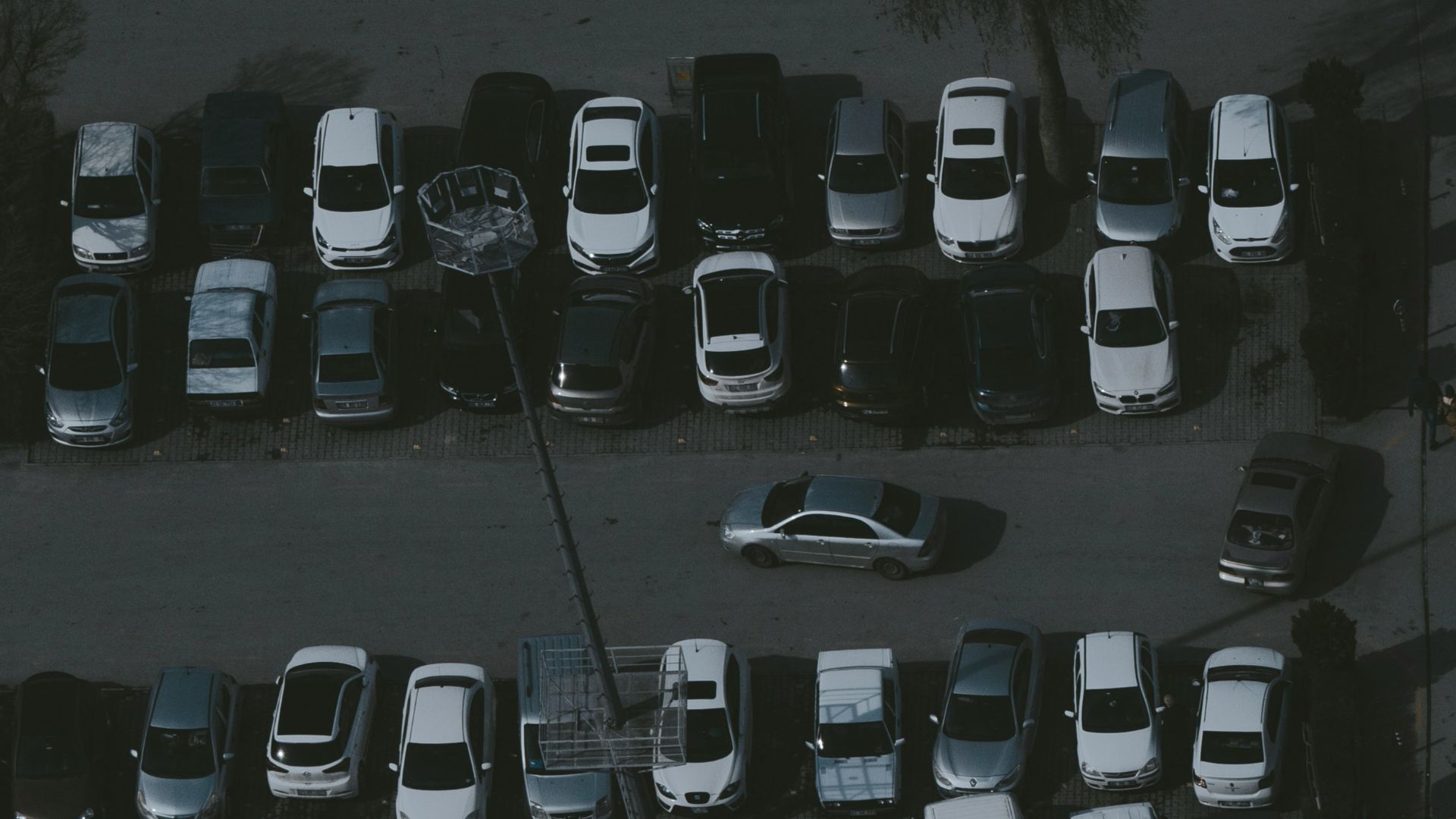 a parking lot filled with lots of parked cars