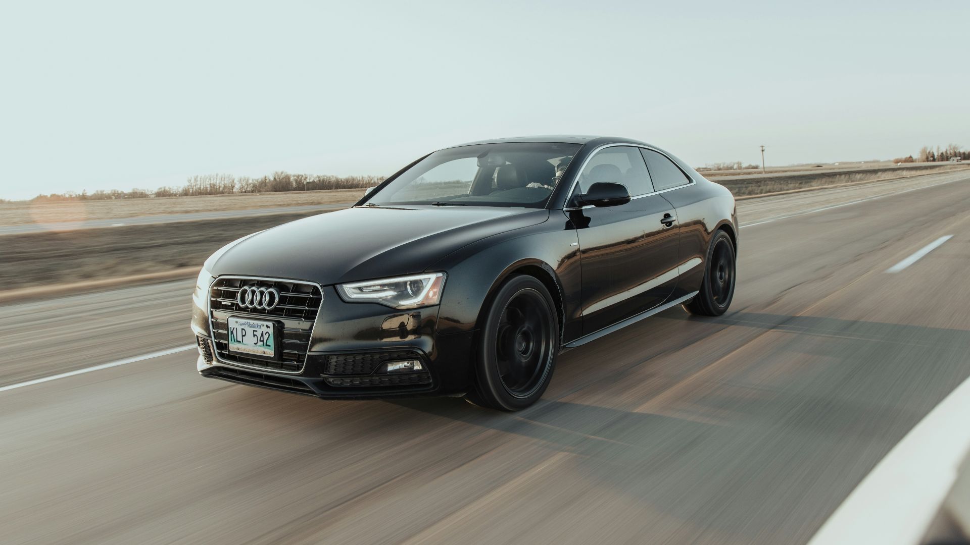 black audi sedan on road during daytime