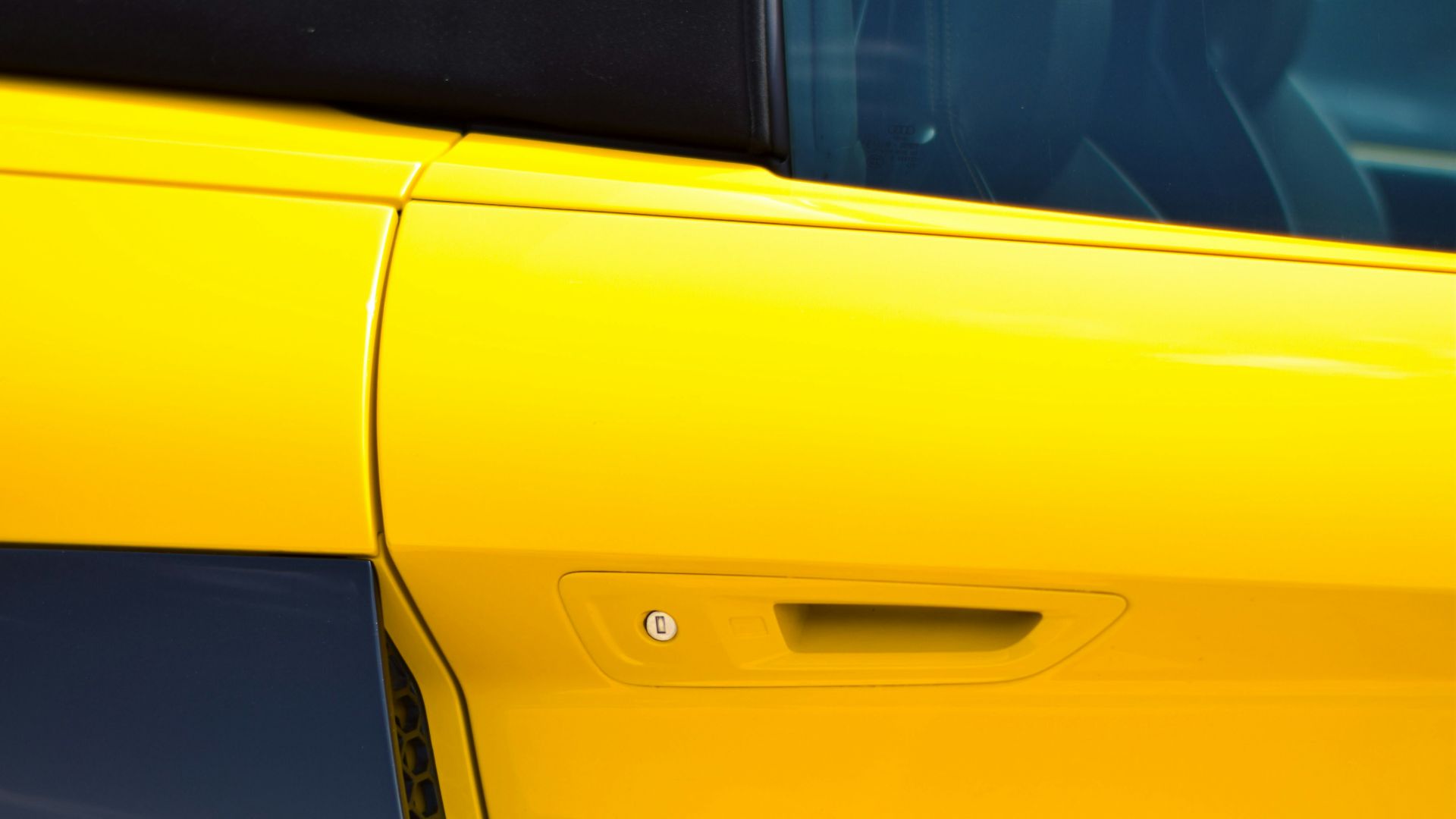 a close up of a yellow sports car door