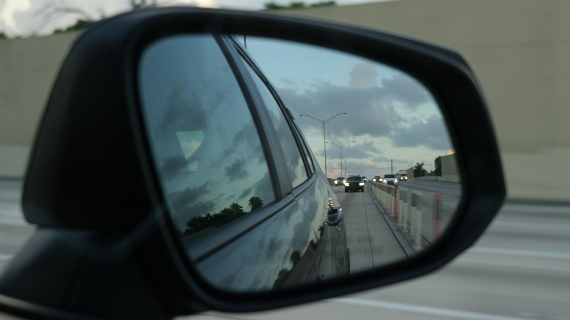 A rear view mirror on the side of a car