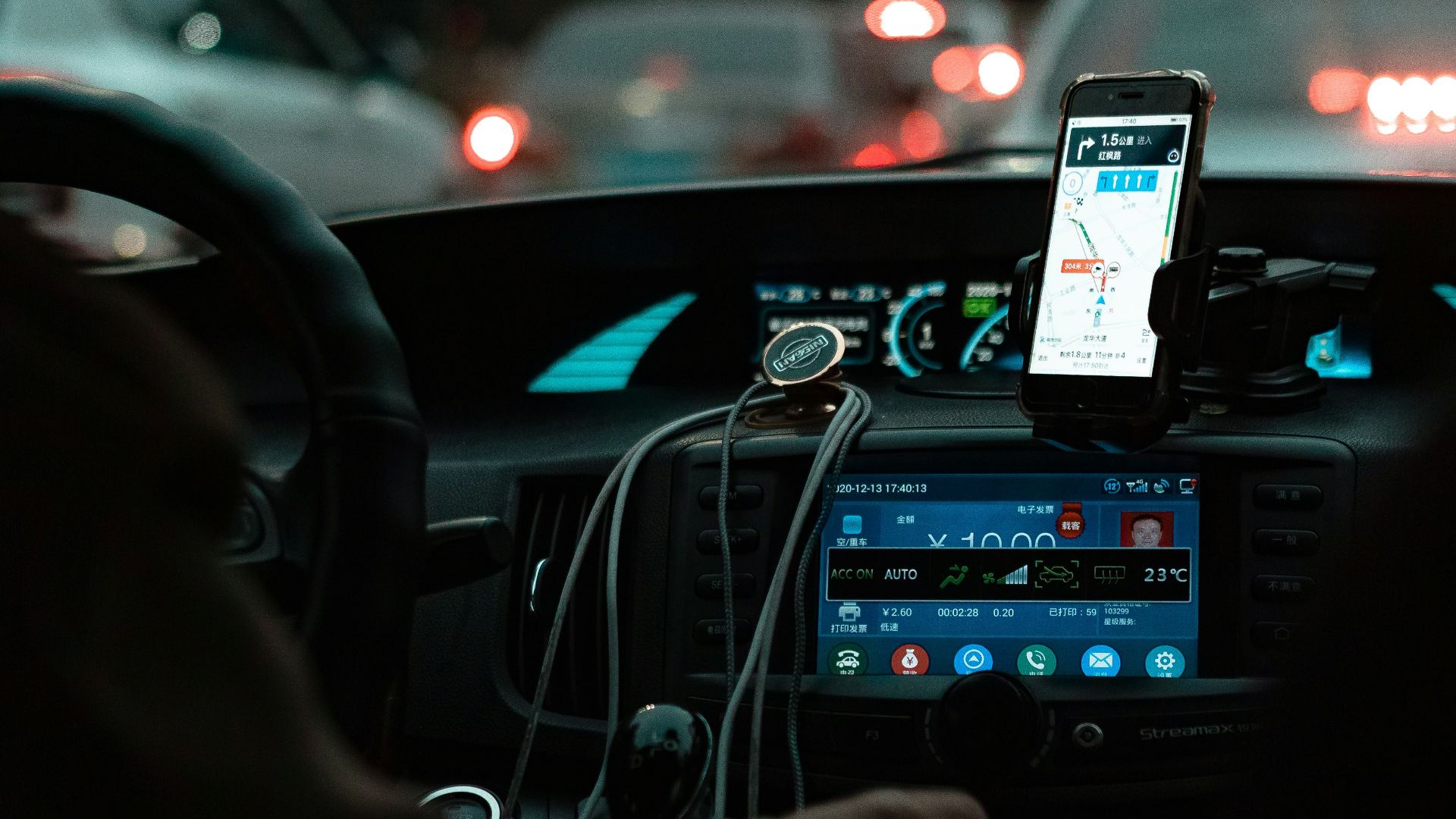 person holding iphone 6 taking photo of cars on road during night time