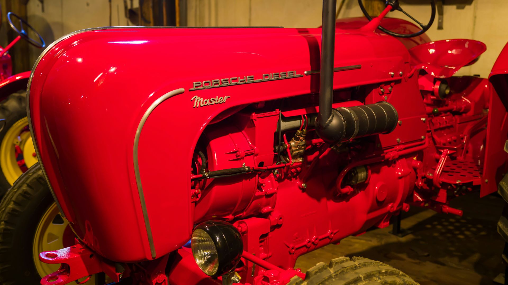 a red tractor in a garage