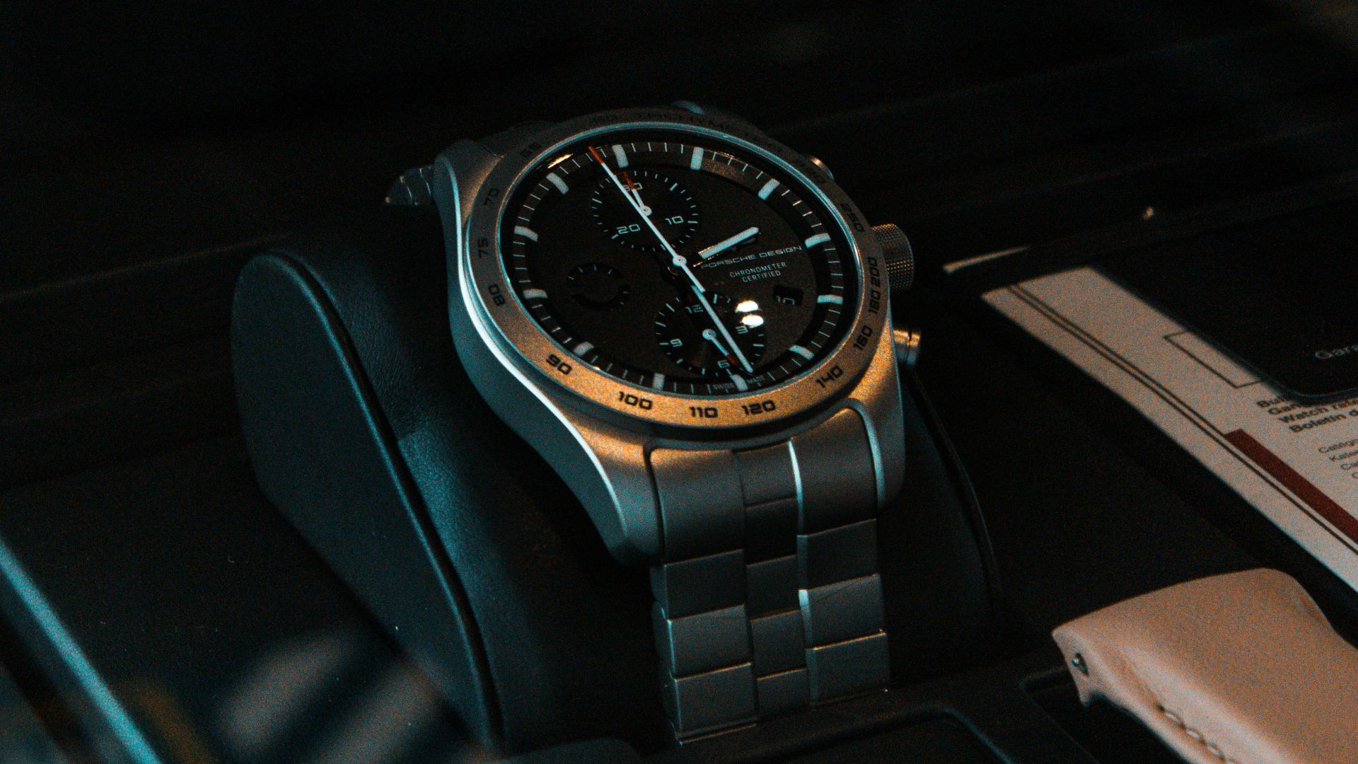 a watch sitting on top of a black table