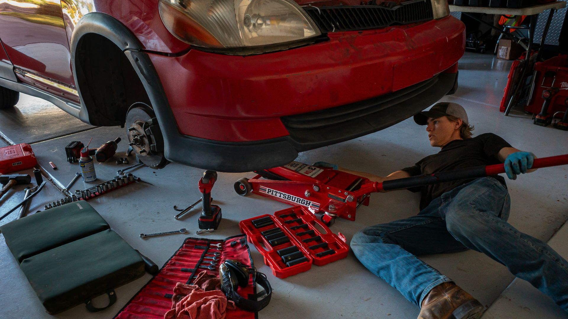 a man working on a car in a garage
