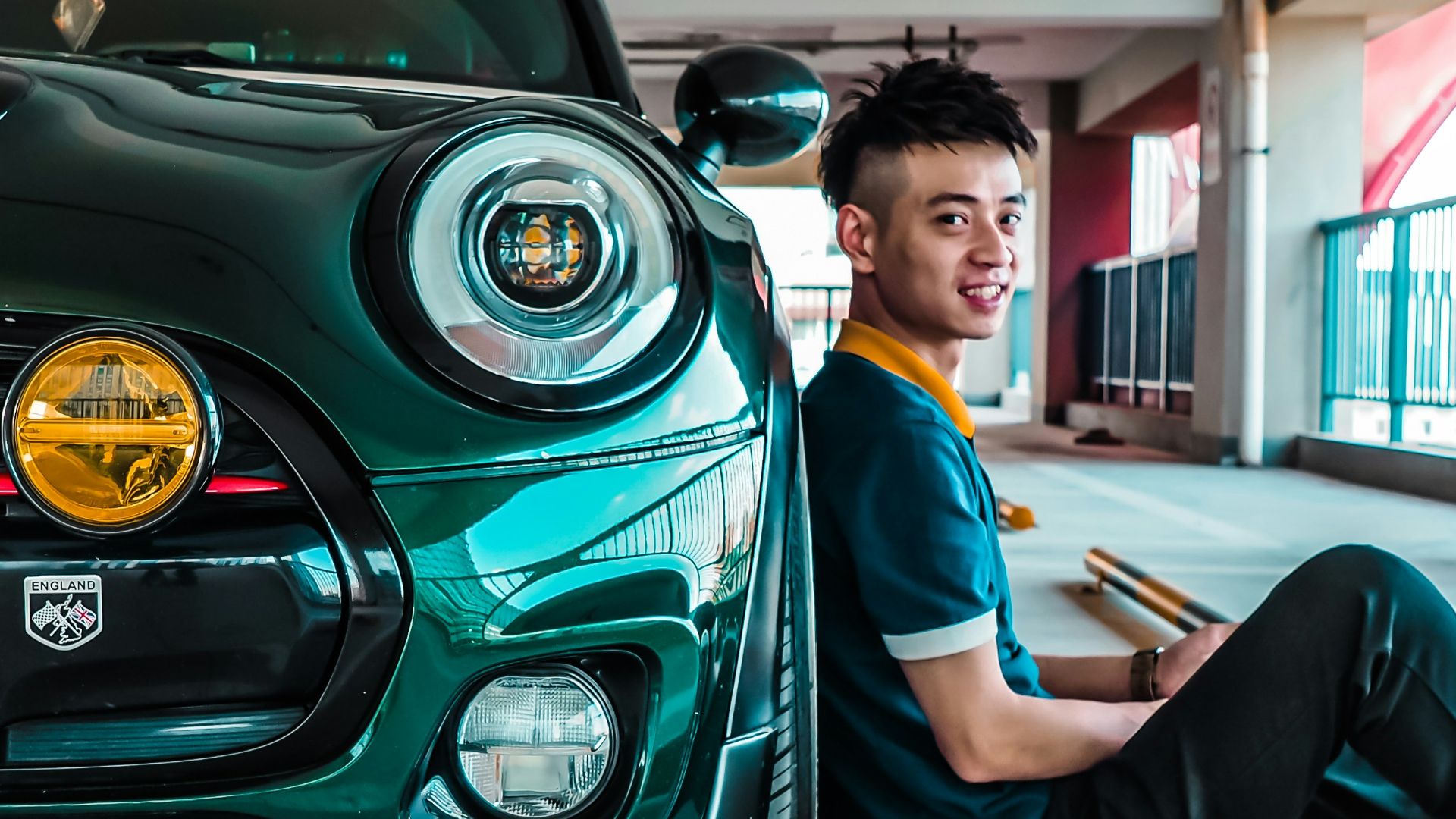 man sitting beside Mini Cooper