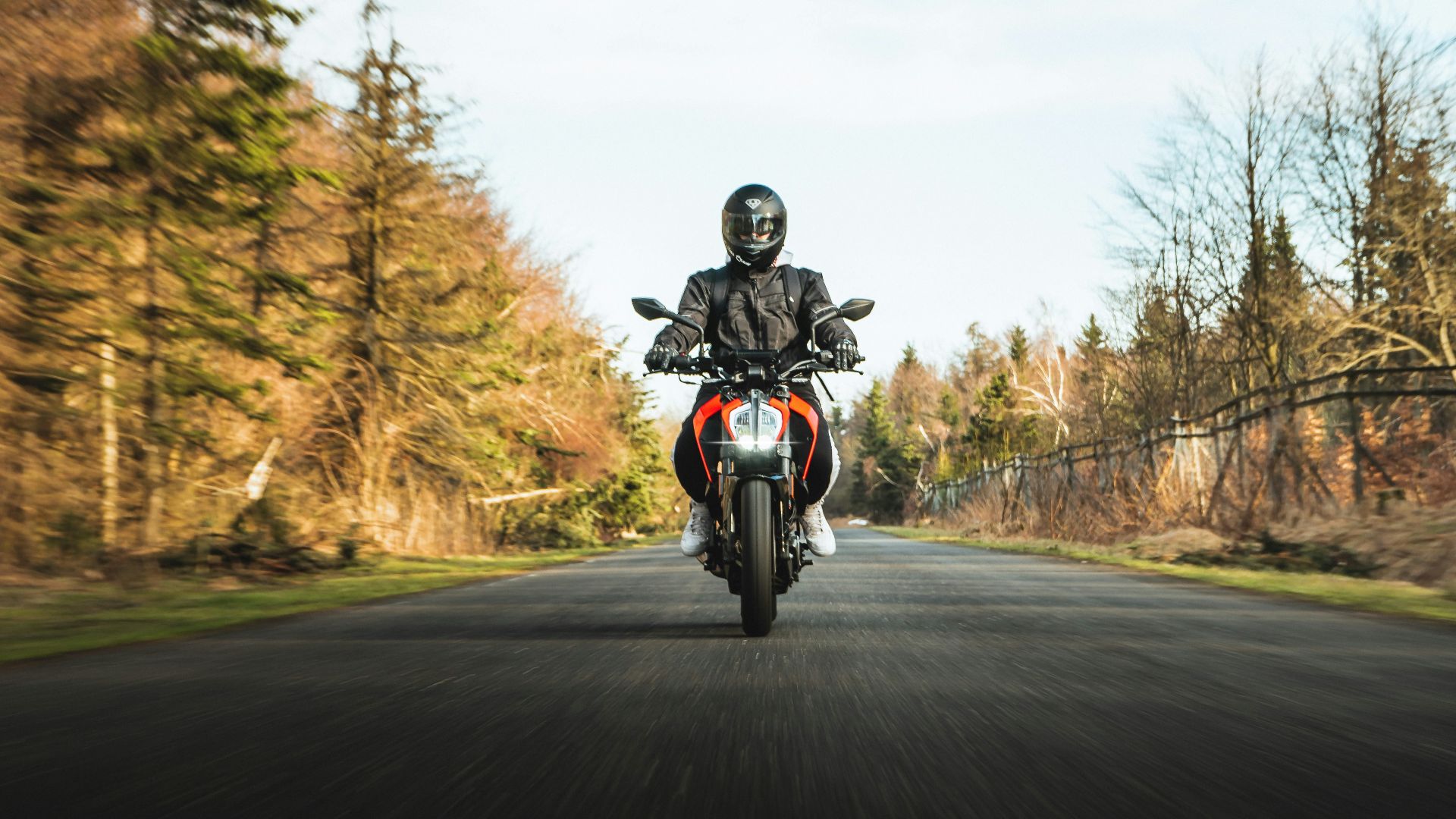 man in black helmet riding motorcycle on road during daytime