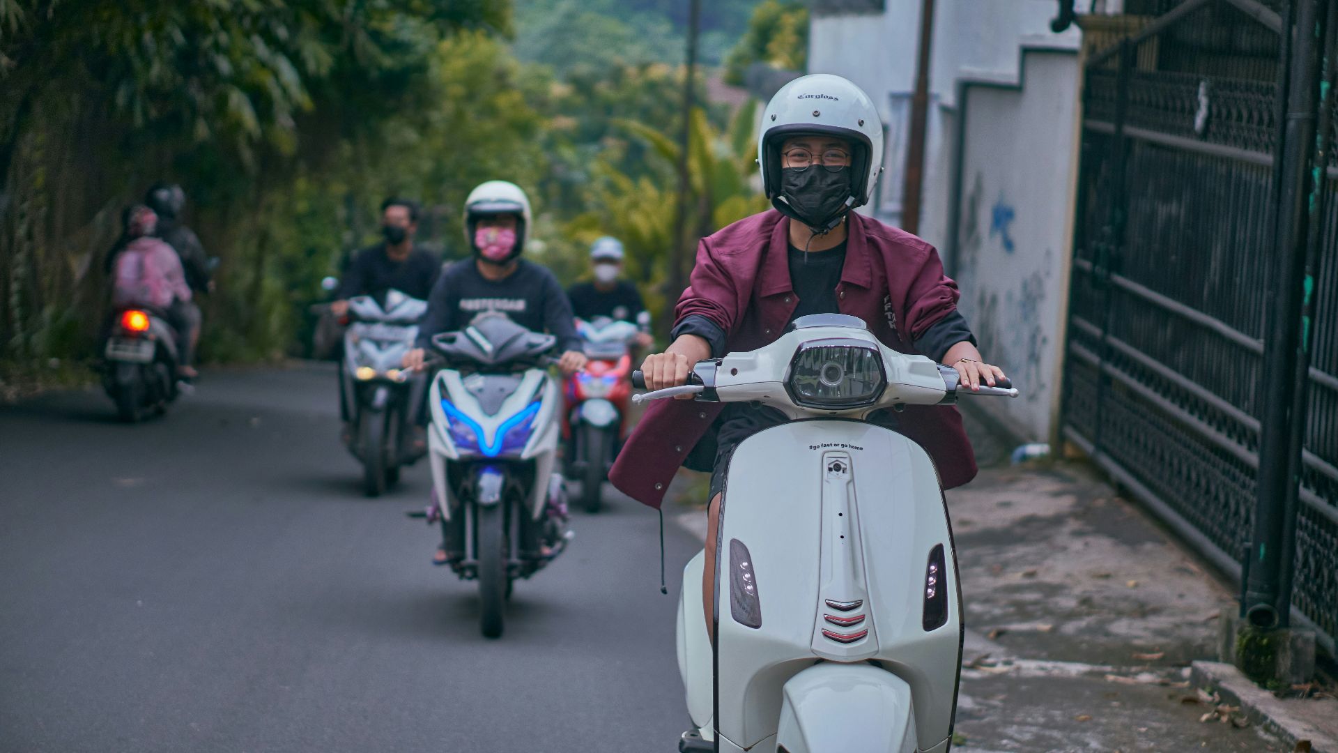 man in black helmet riding white and red motorcycle during daytime