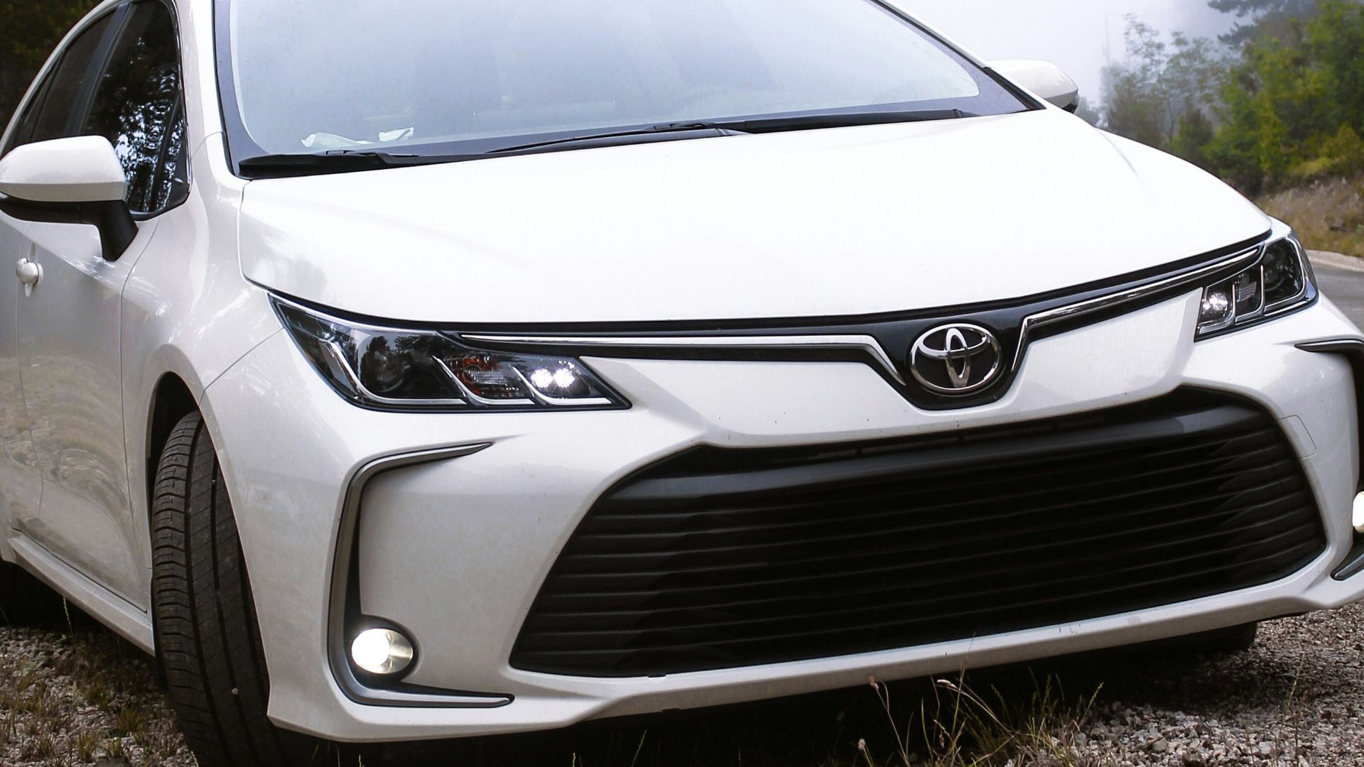 a white car parked on the side of a road