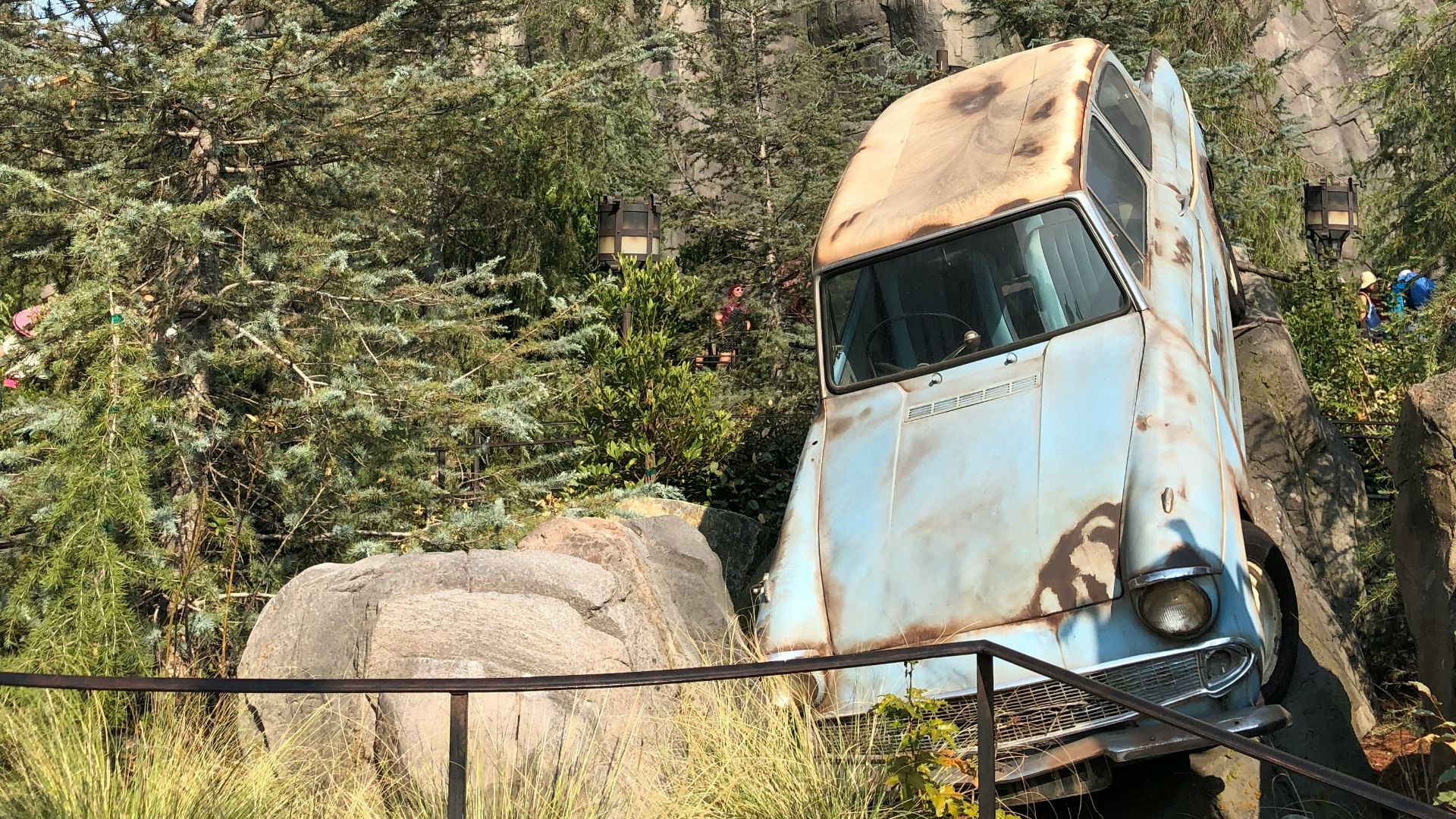 white volkswagen beetle parked near brown concrete building during daytime