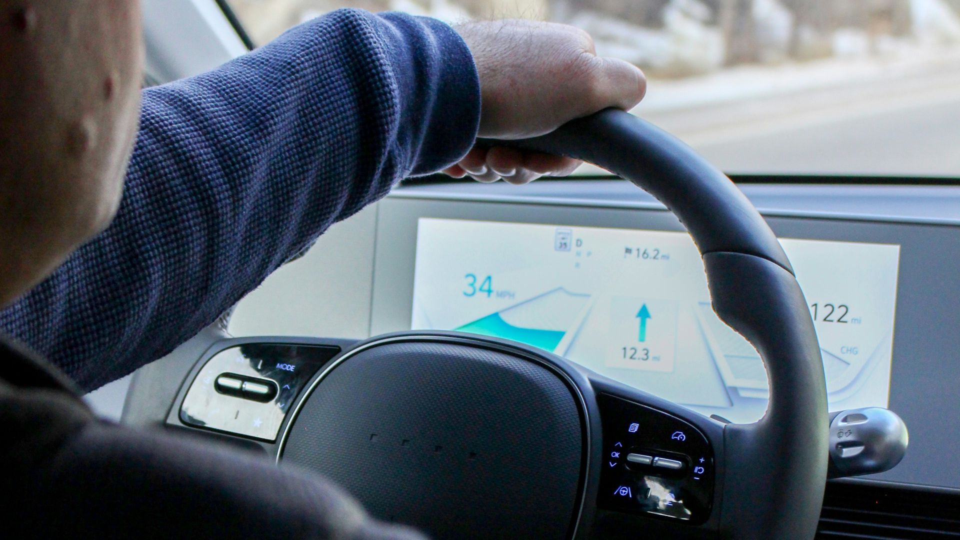 a man driving a car on a snowy road