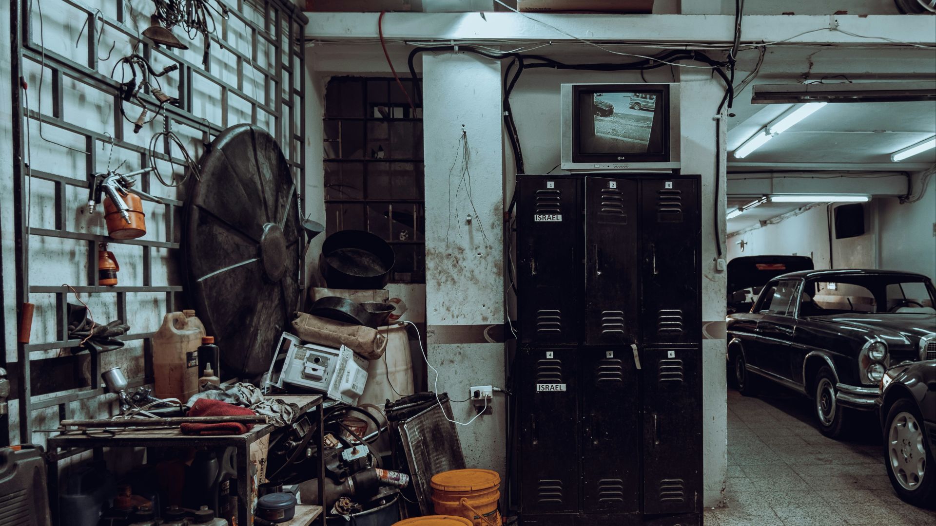 a garage filled with lots of junk and old cars