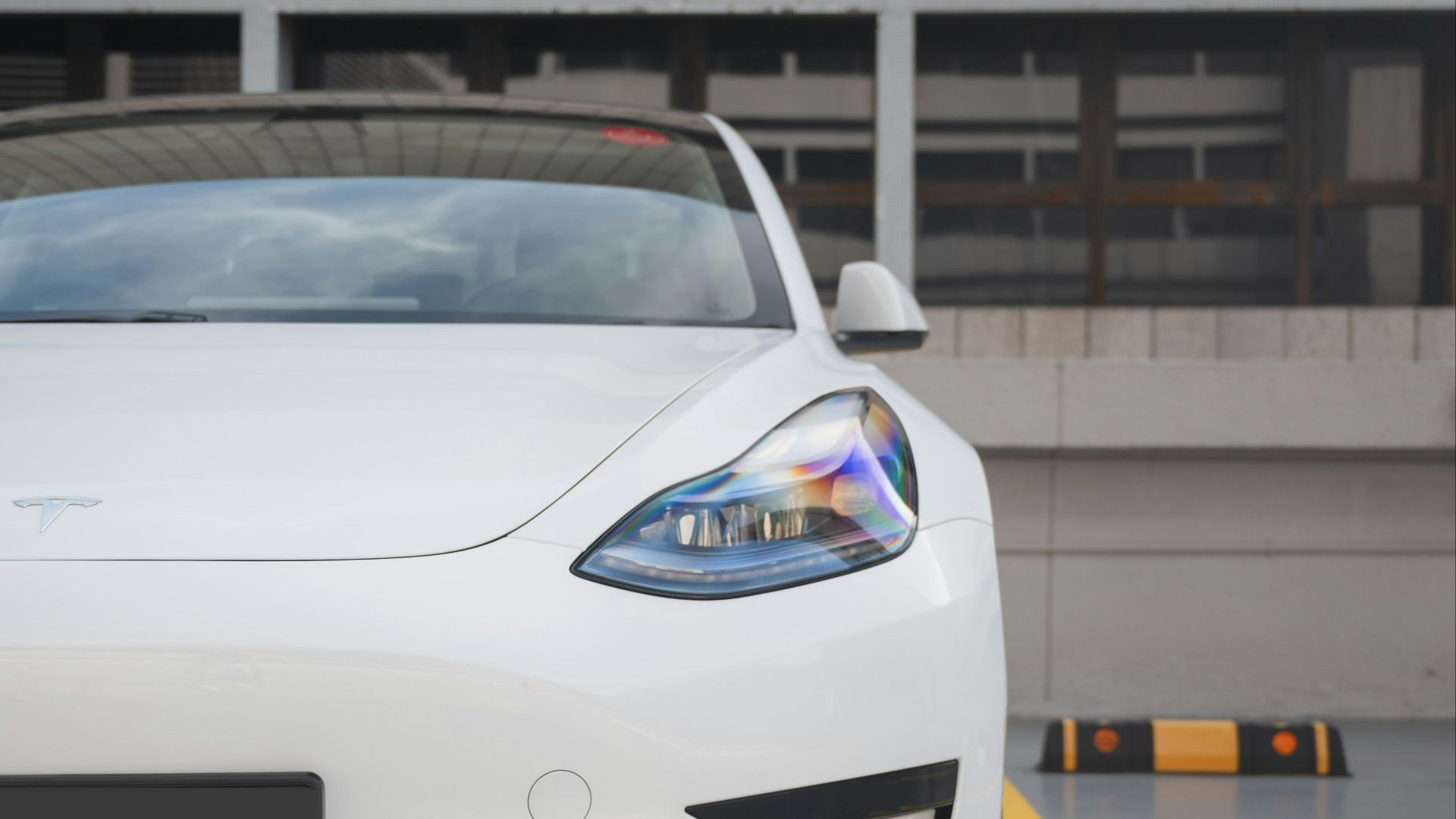 a white sports car parked in a parking lot
