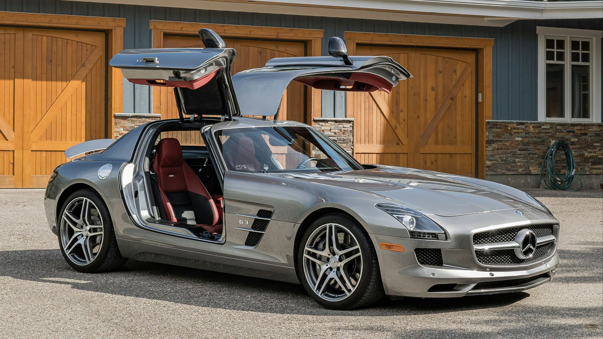 A silver sports car parked in front of a house