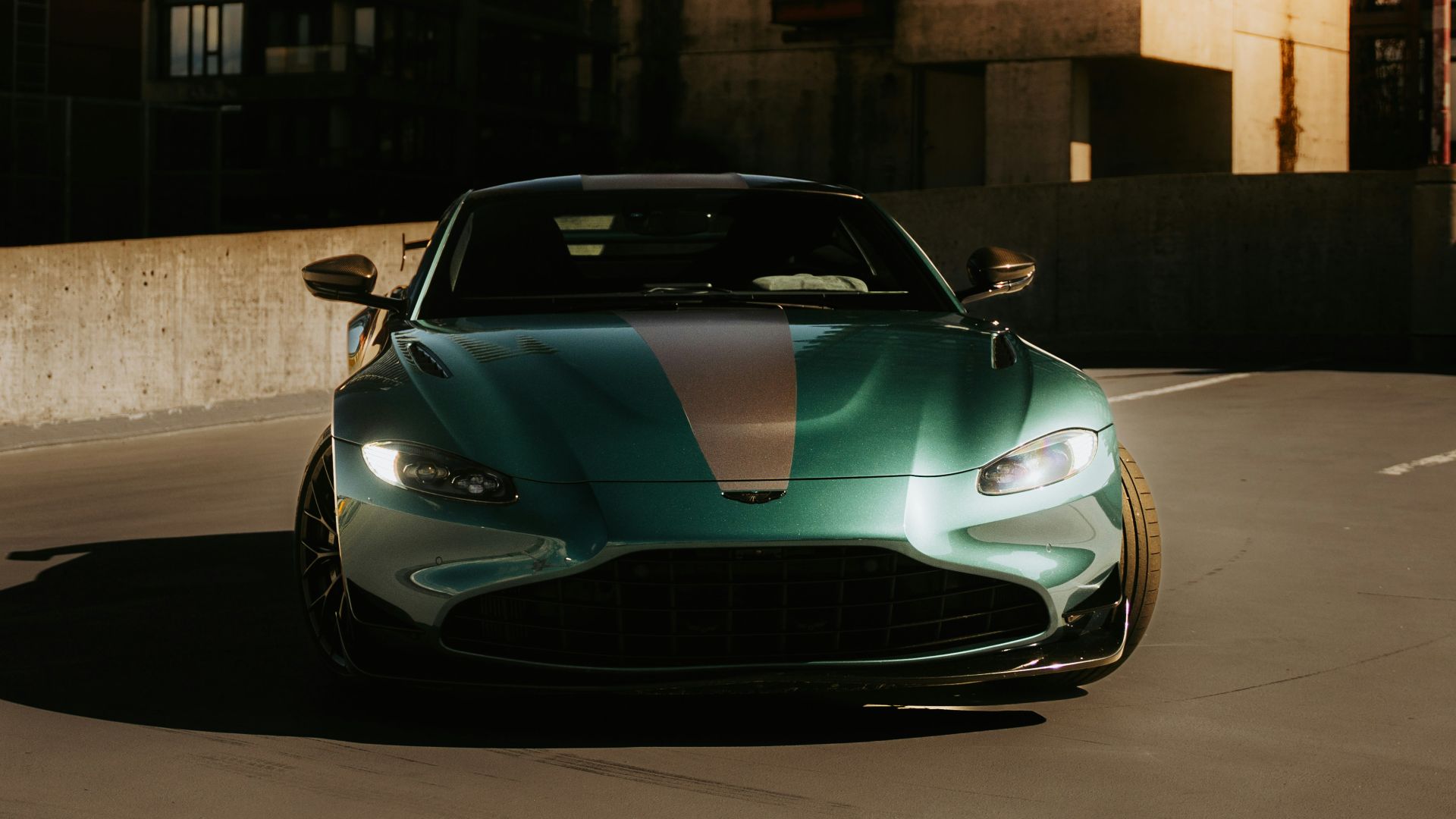 Green sports car parked in urban setting.