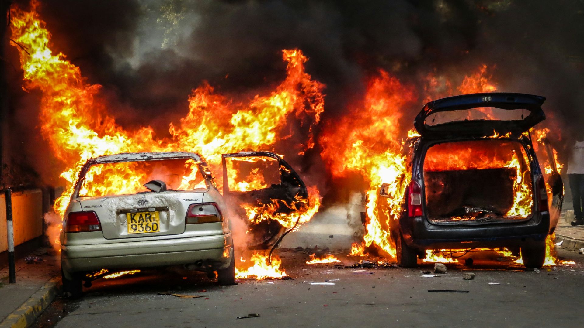 Cars are engulfed in flames and smoke.
