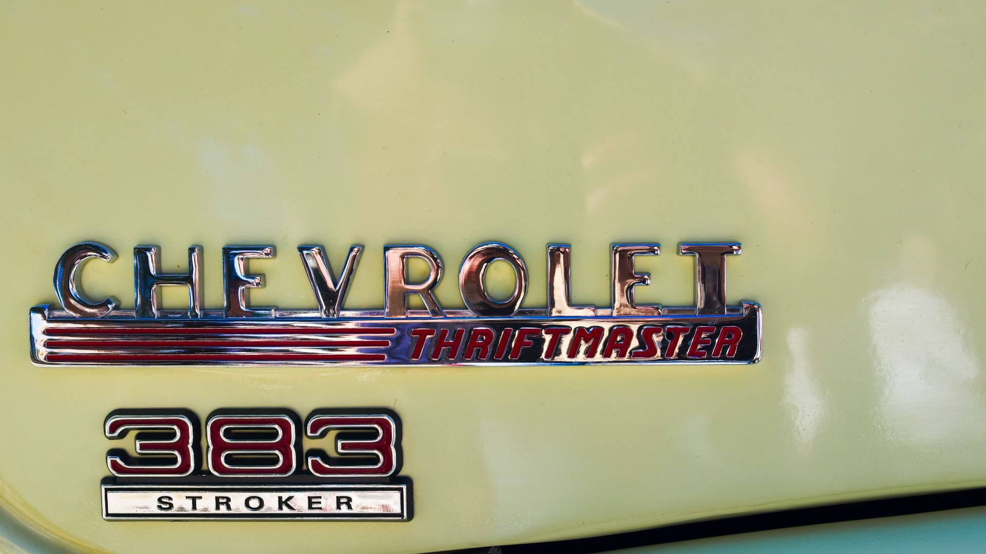 a close up of the emblem on a yellow car