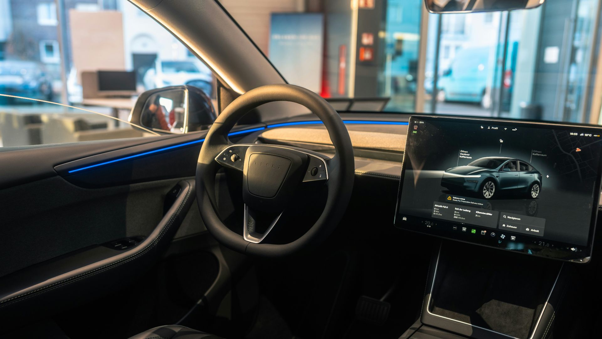 The interior of a car with a laptop on the dashboard
