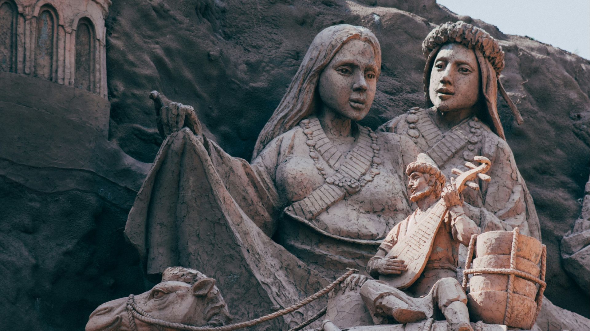 a statue of a woman and a man riding a camel