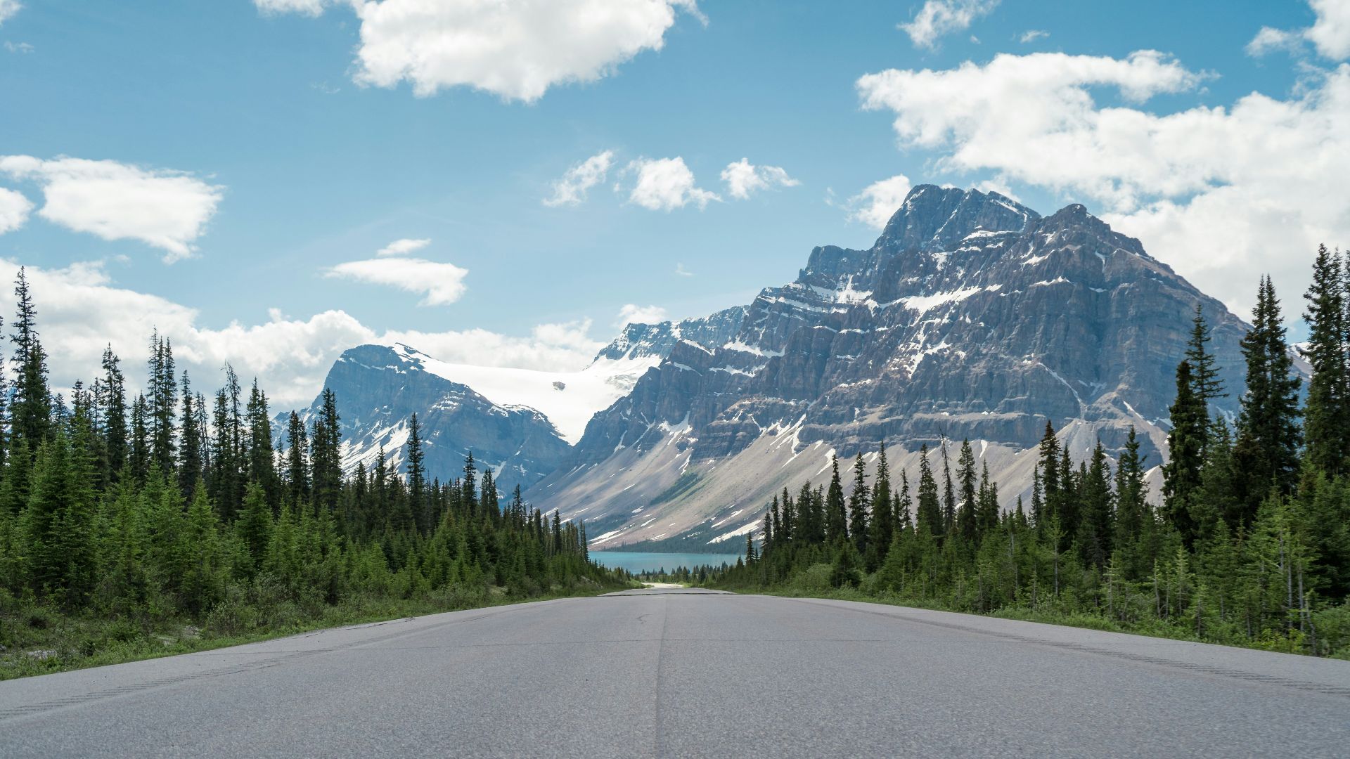 a road with a mountain in the background
