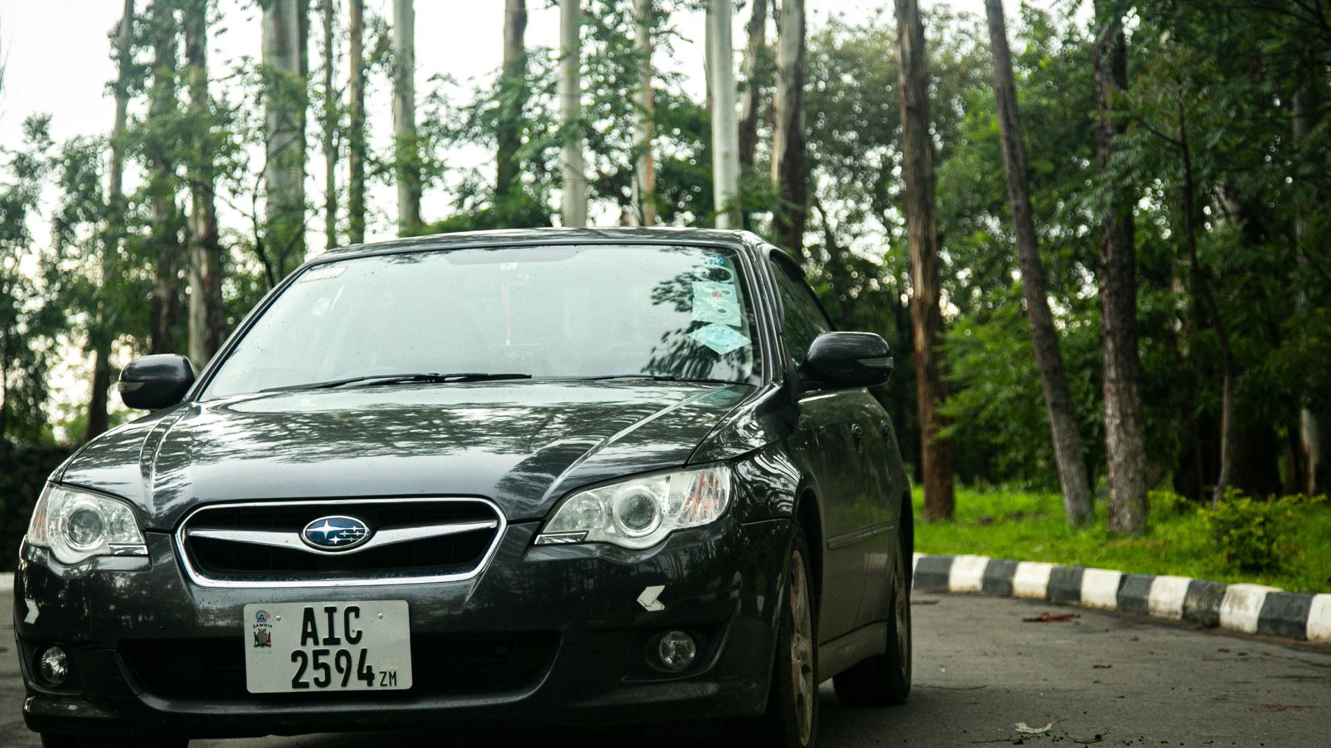 a black car parked on the side of the road