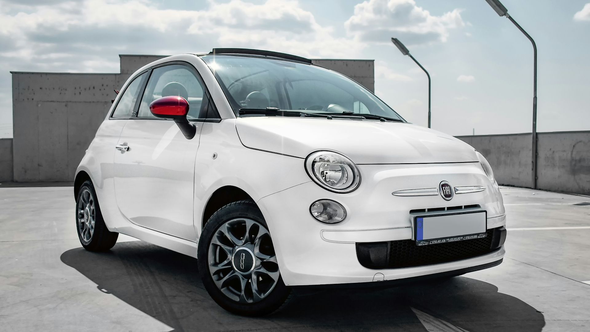 white 3-door hatchback on gray floor