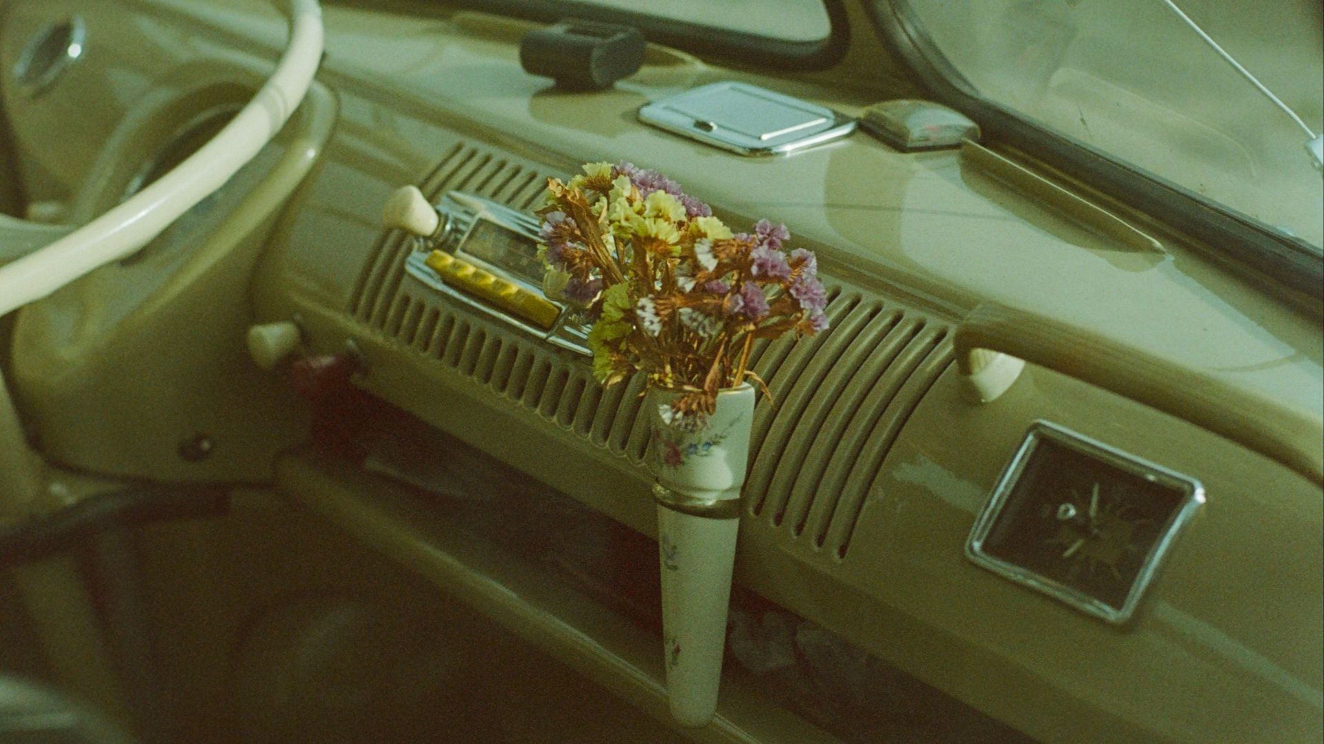 The interior of a car with a steering wheel and dashboard