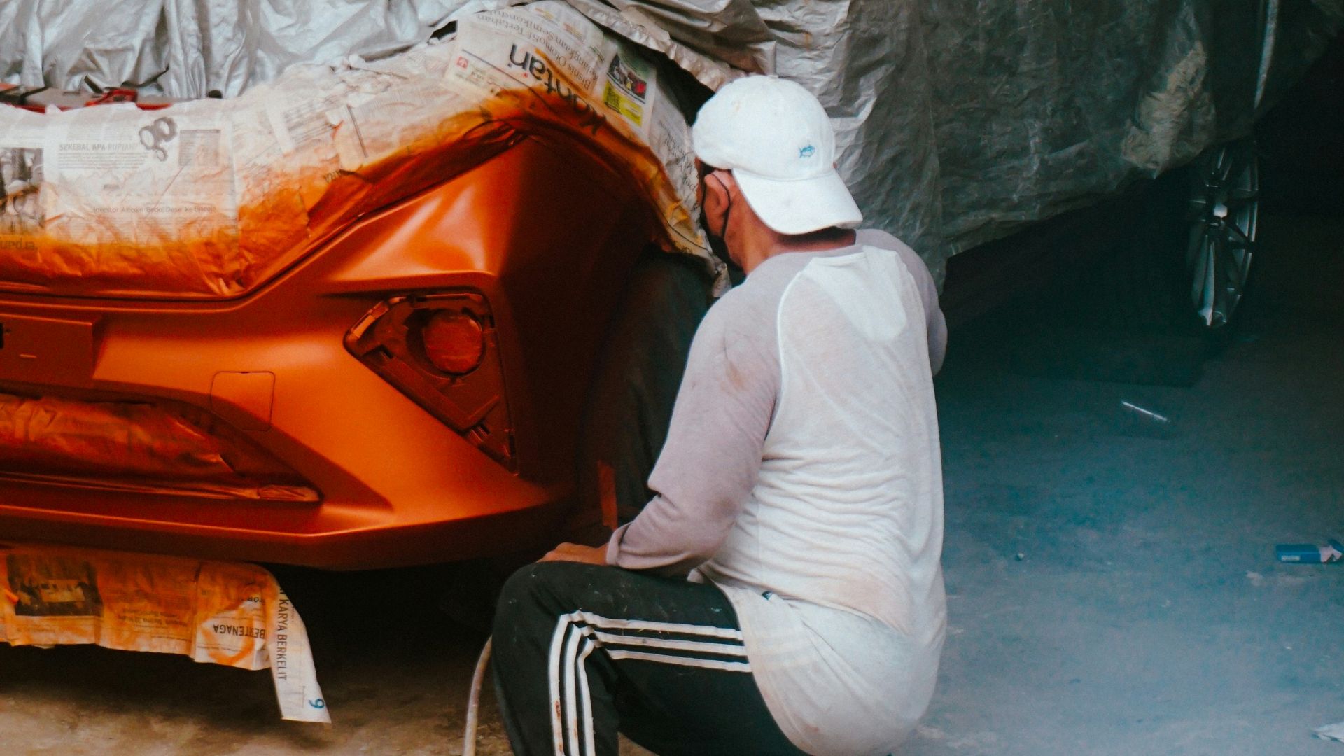a man working on a car in a garage