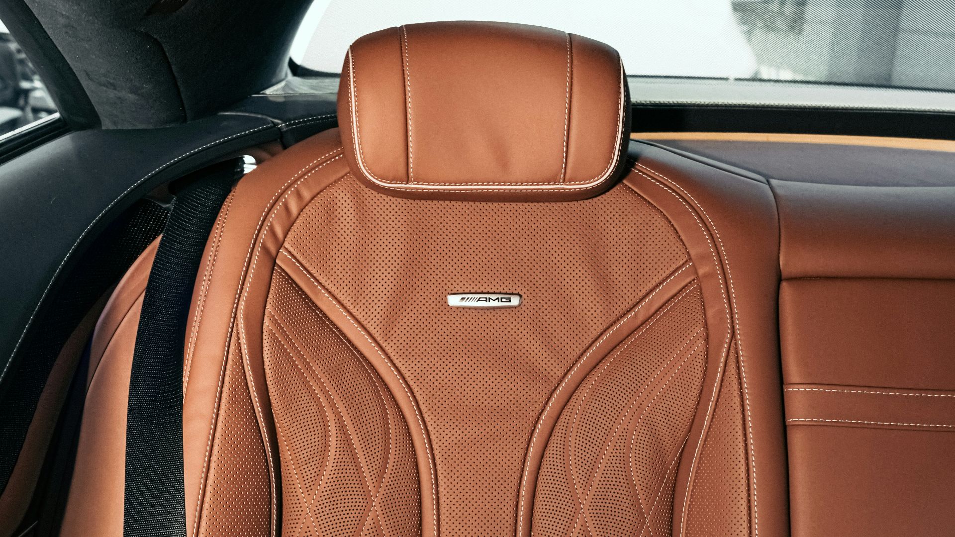 brown leather backpack on car seat