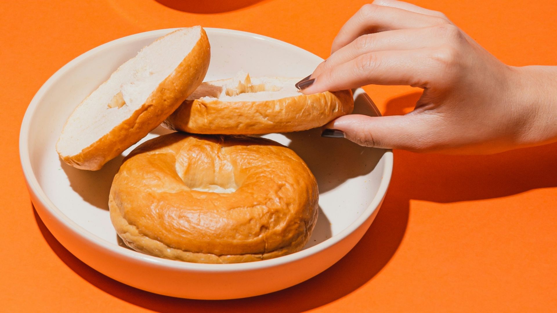 person holding white ceramic mug with brown liquid