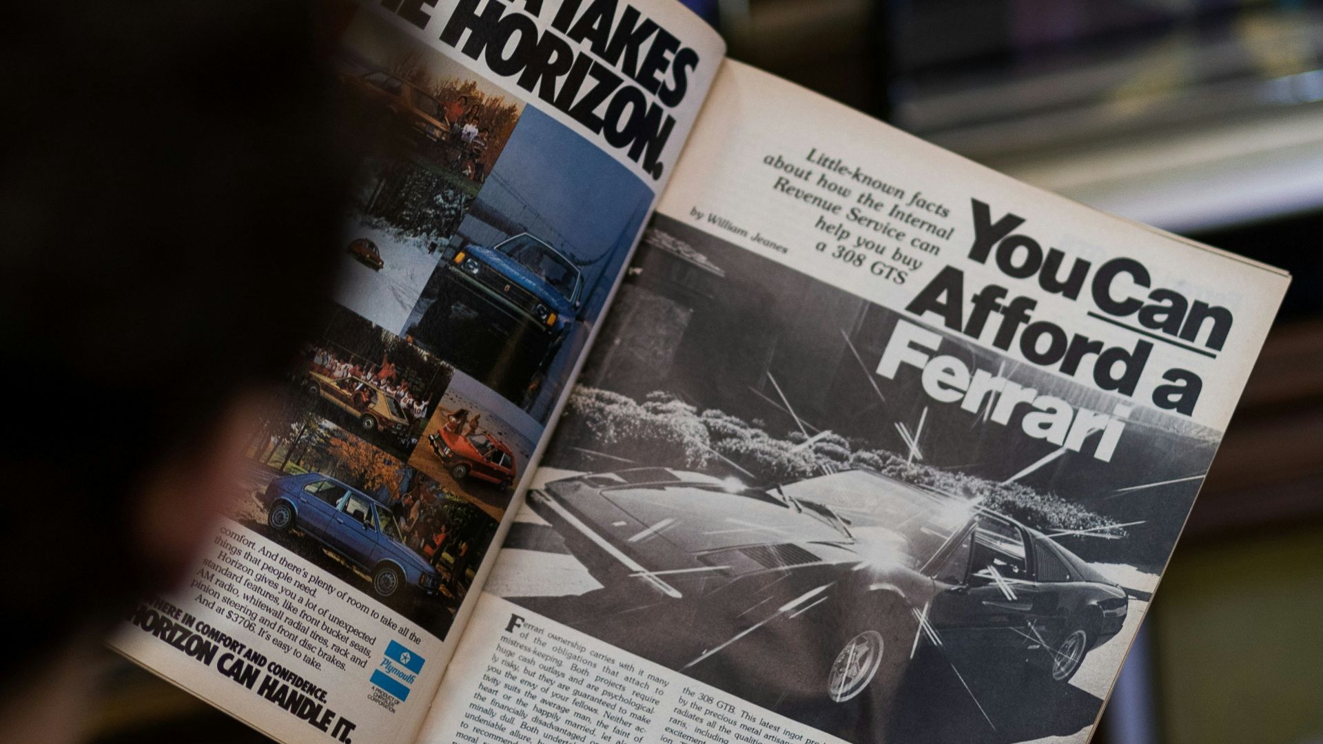a man reading a newspaper with a picture of a car