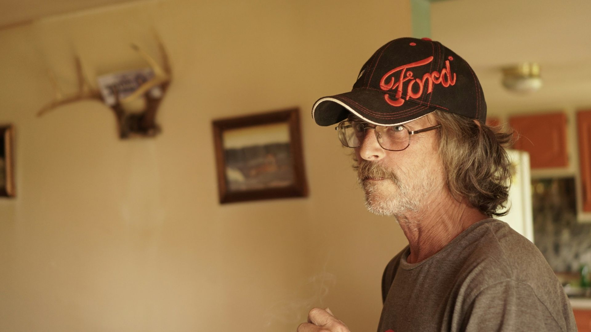 a man in a hat smoking a cigarette