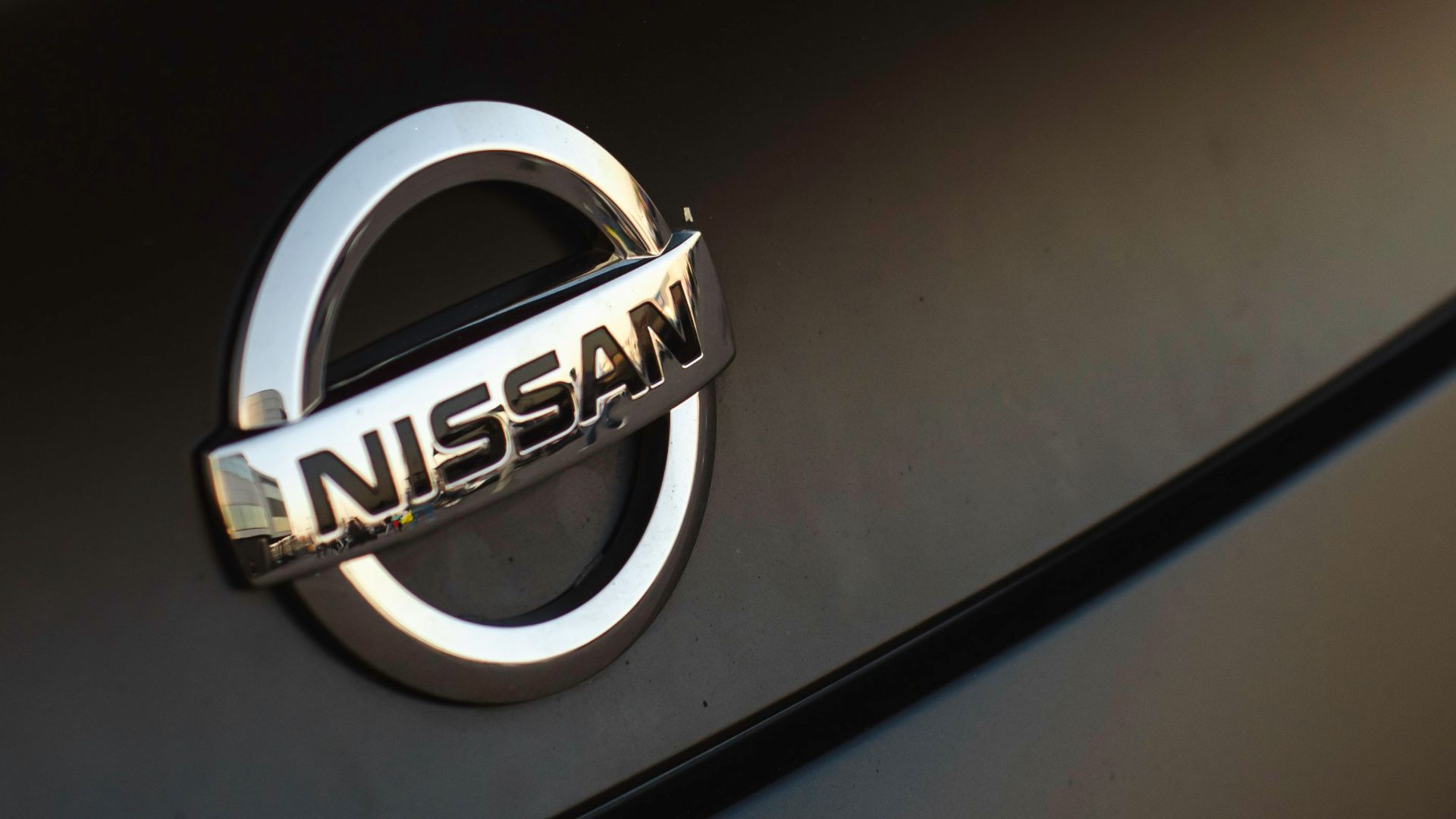 a close up of a nissan emblem on a car