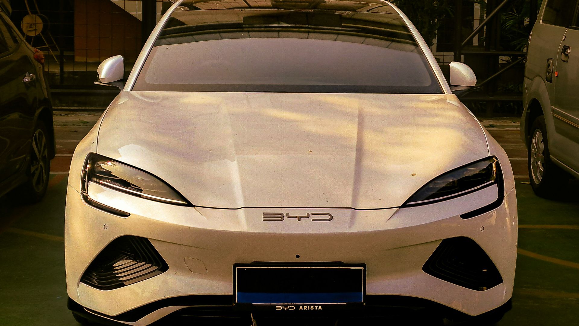 A white sports car parked in a parking lot