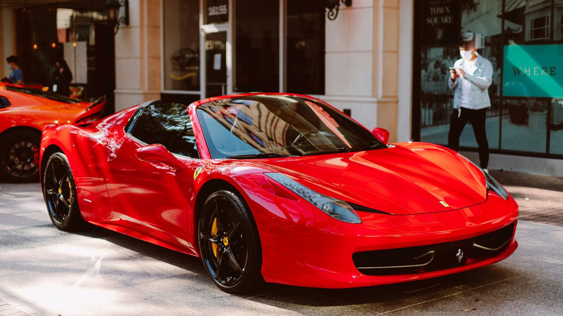 red ferrari 458 italia parked in front of store