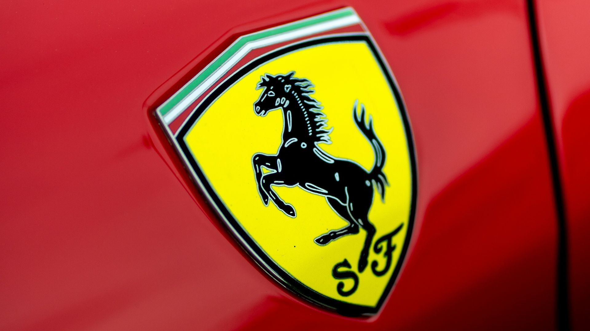 a close up of a ferrari badge on a red car