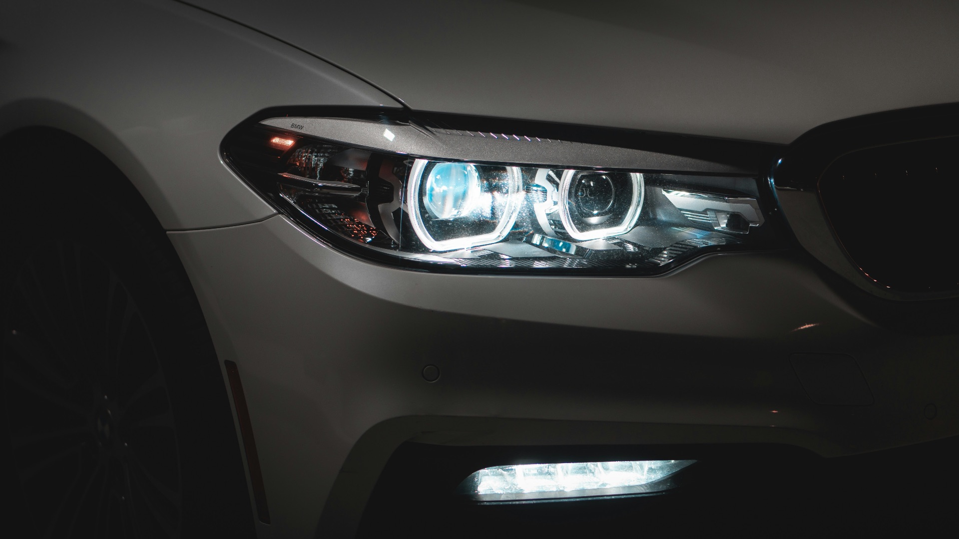 gray car with white and blue lights